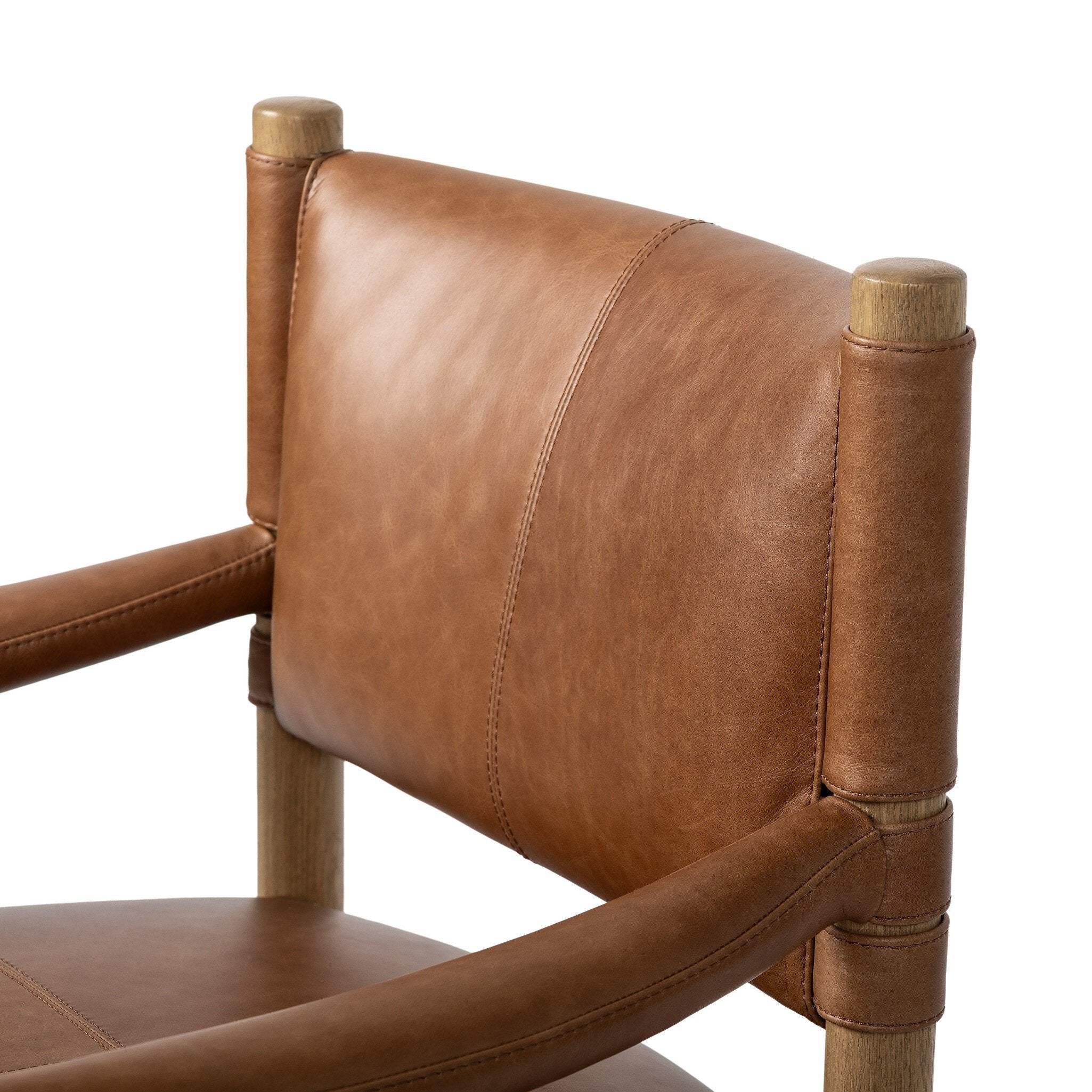 Brown leather dining armchair with wooden frame on a white background.