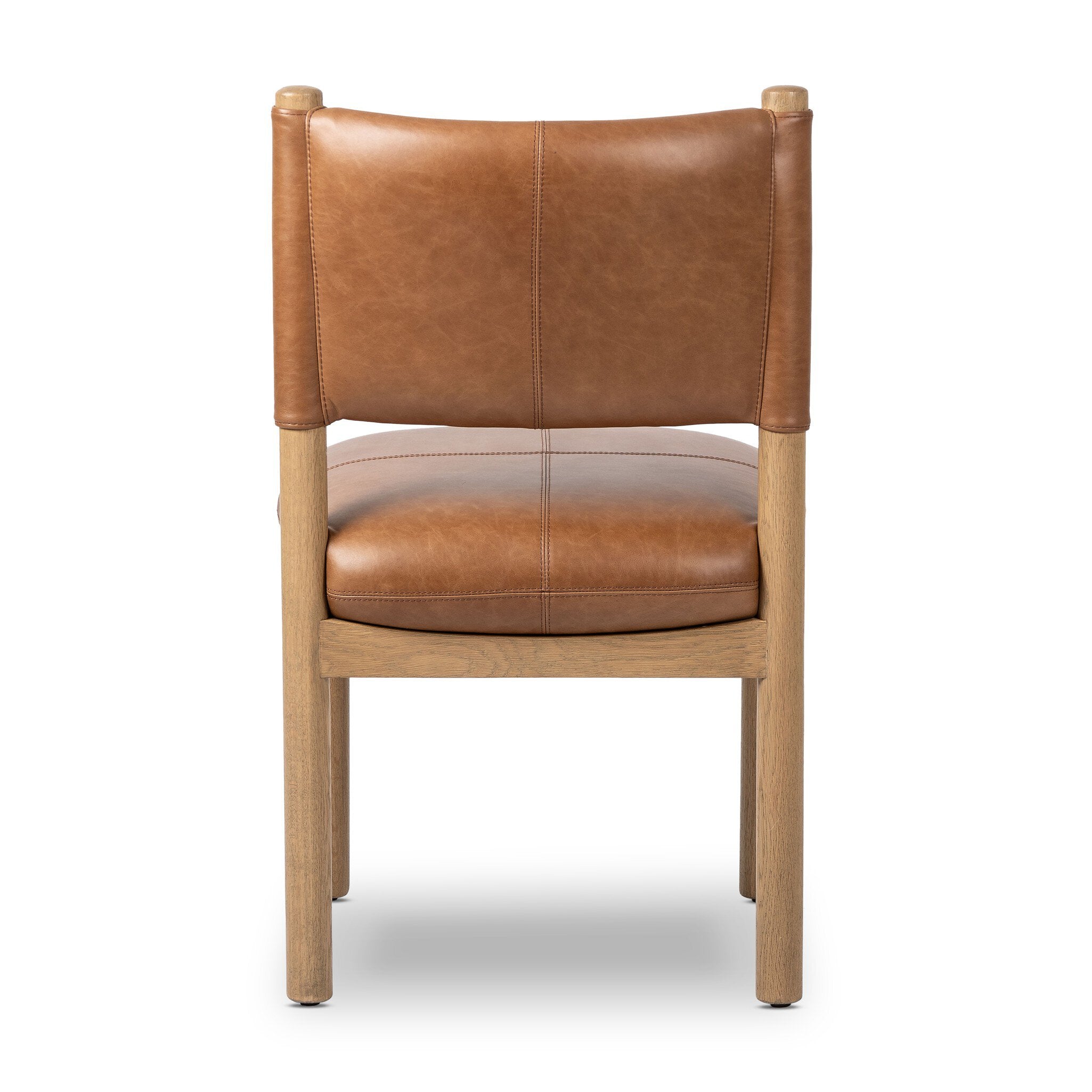 The back of a brown leather chair on a white background.