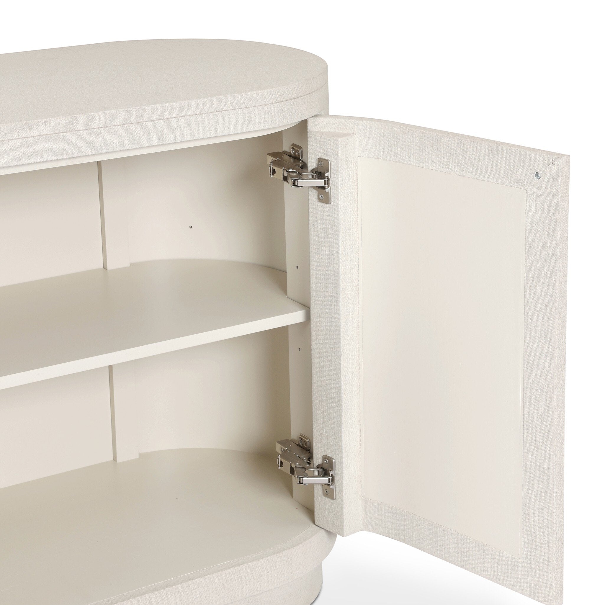Close up of a white oval shaped sideboard cabinet with four doors on a white background.