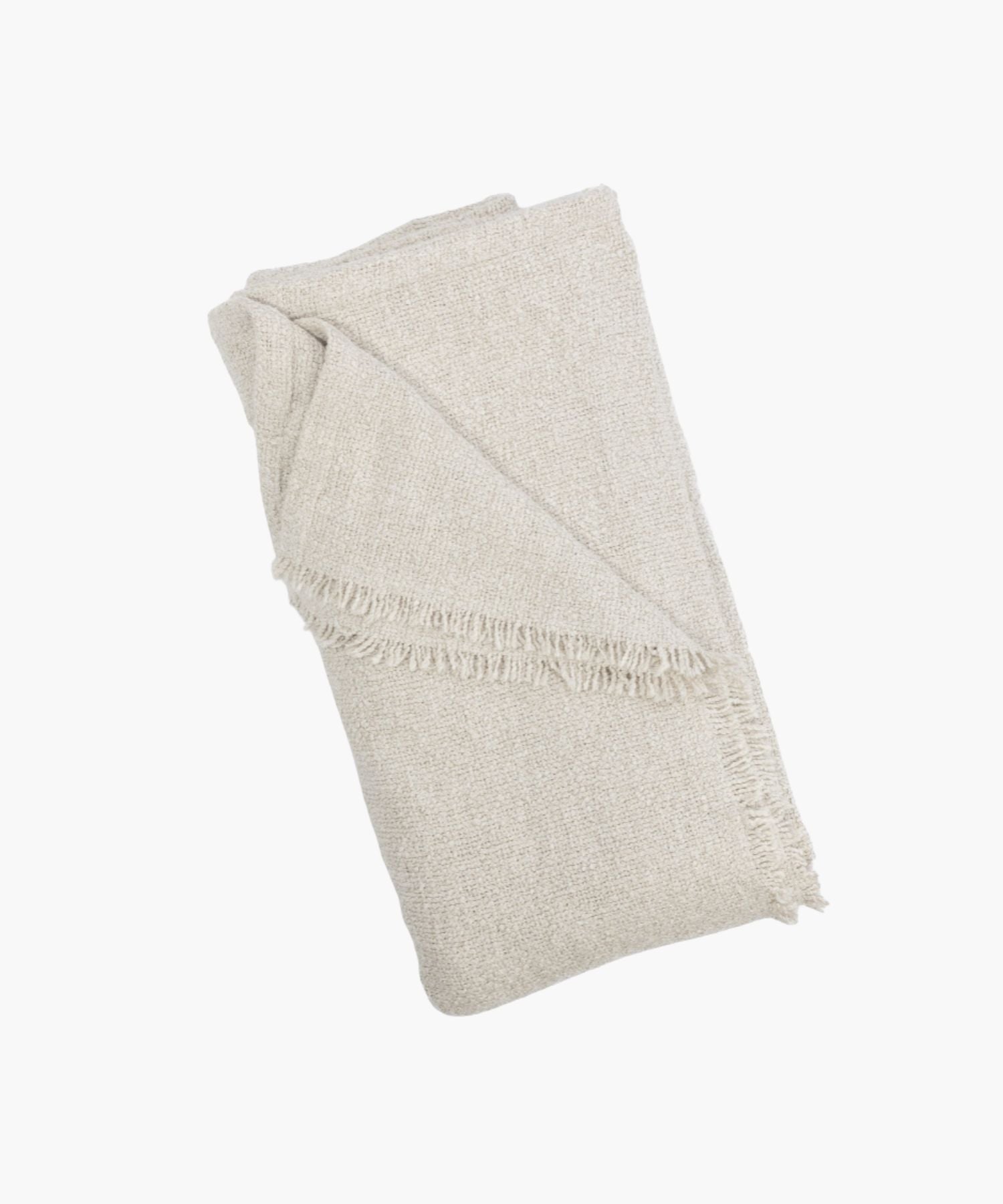 Folded cream coverlet with a boucle texture and short fringe detail at the edge.