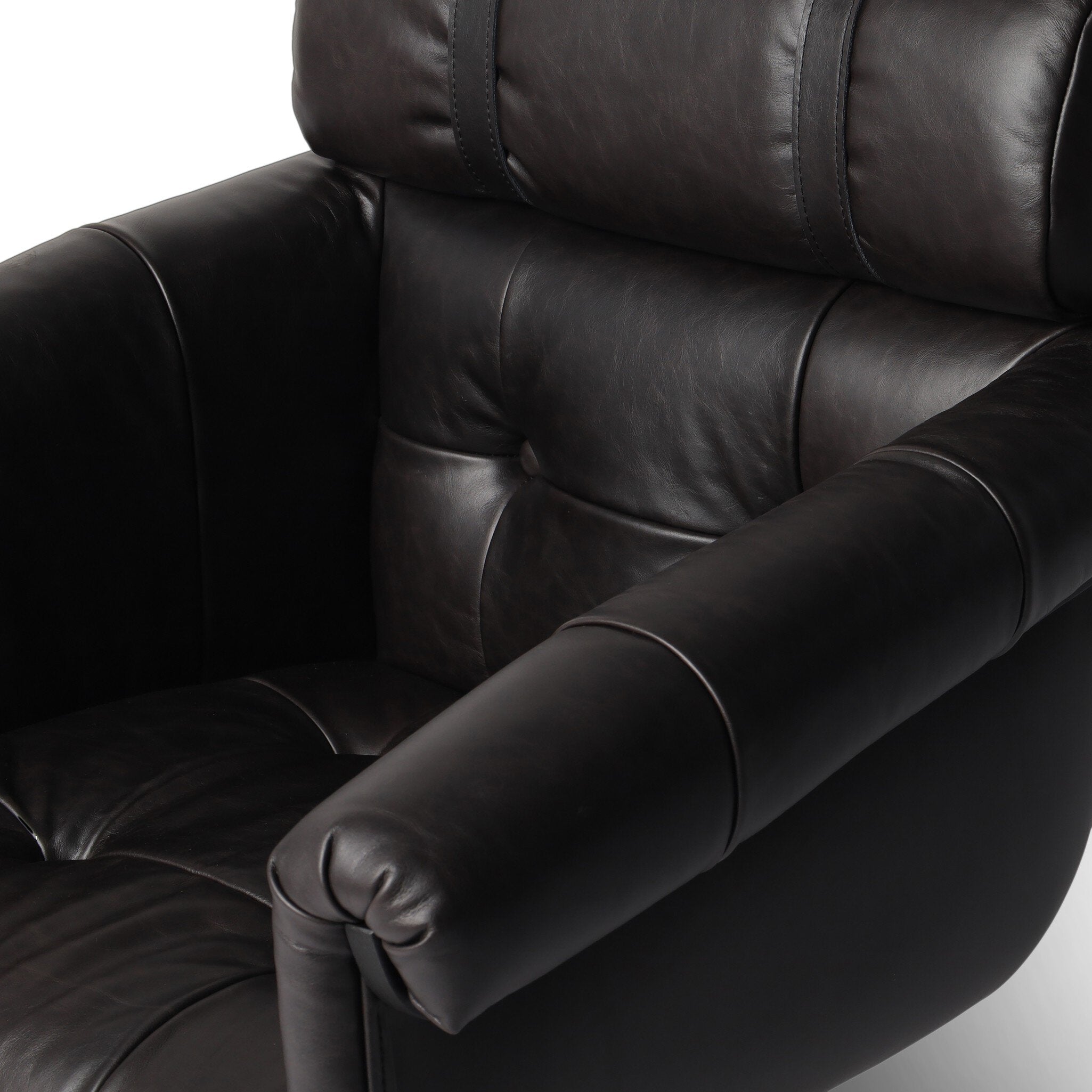 Close up of a tufted black leather desk chair showing it color and texture. 