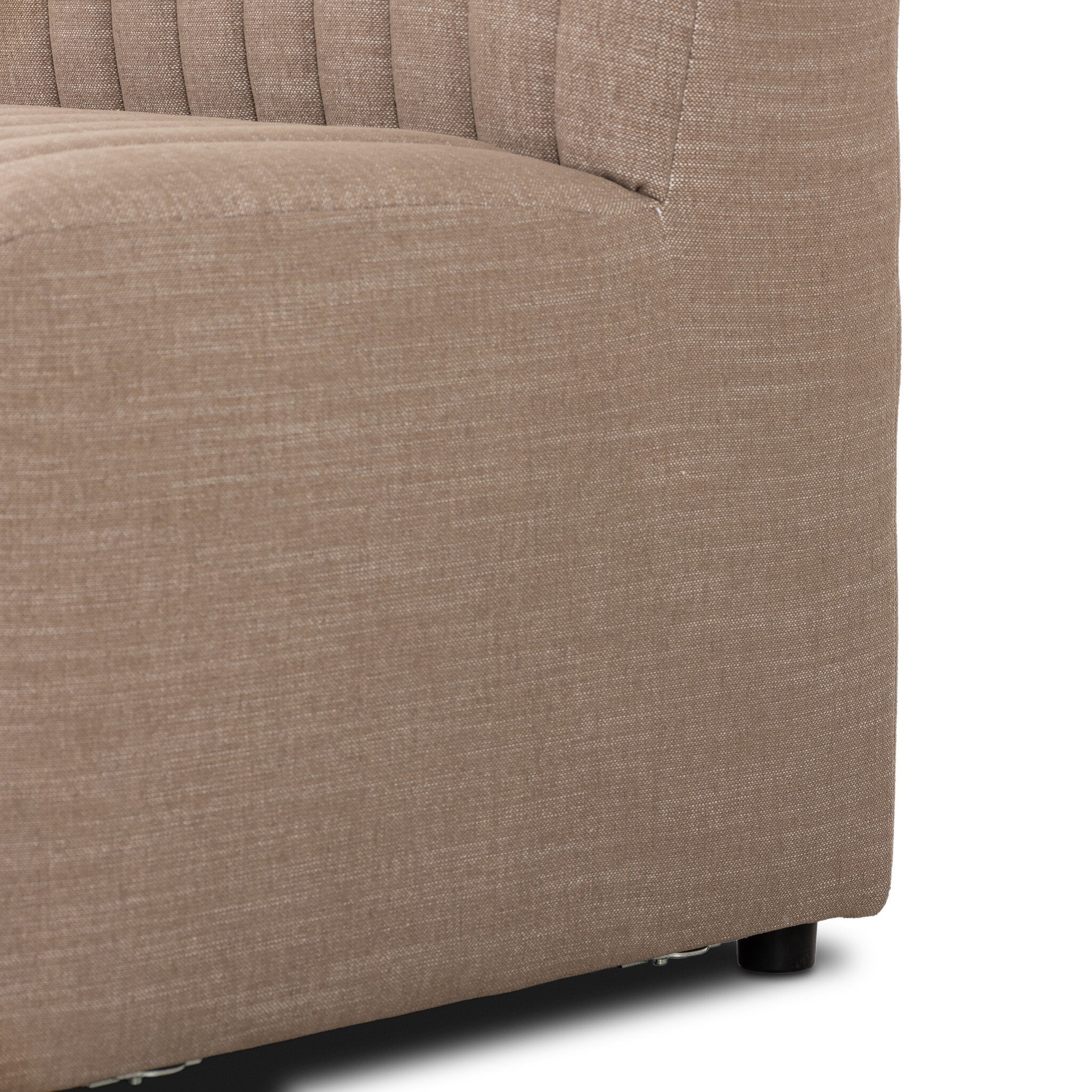 Close up of a taupe dining banquette with quilted texture on a white background.