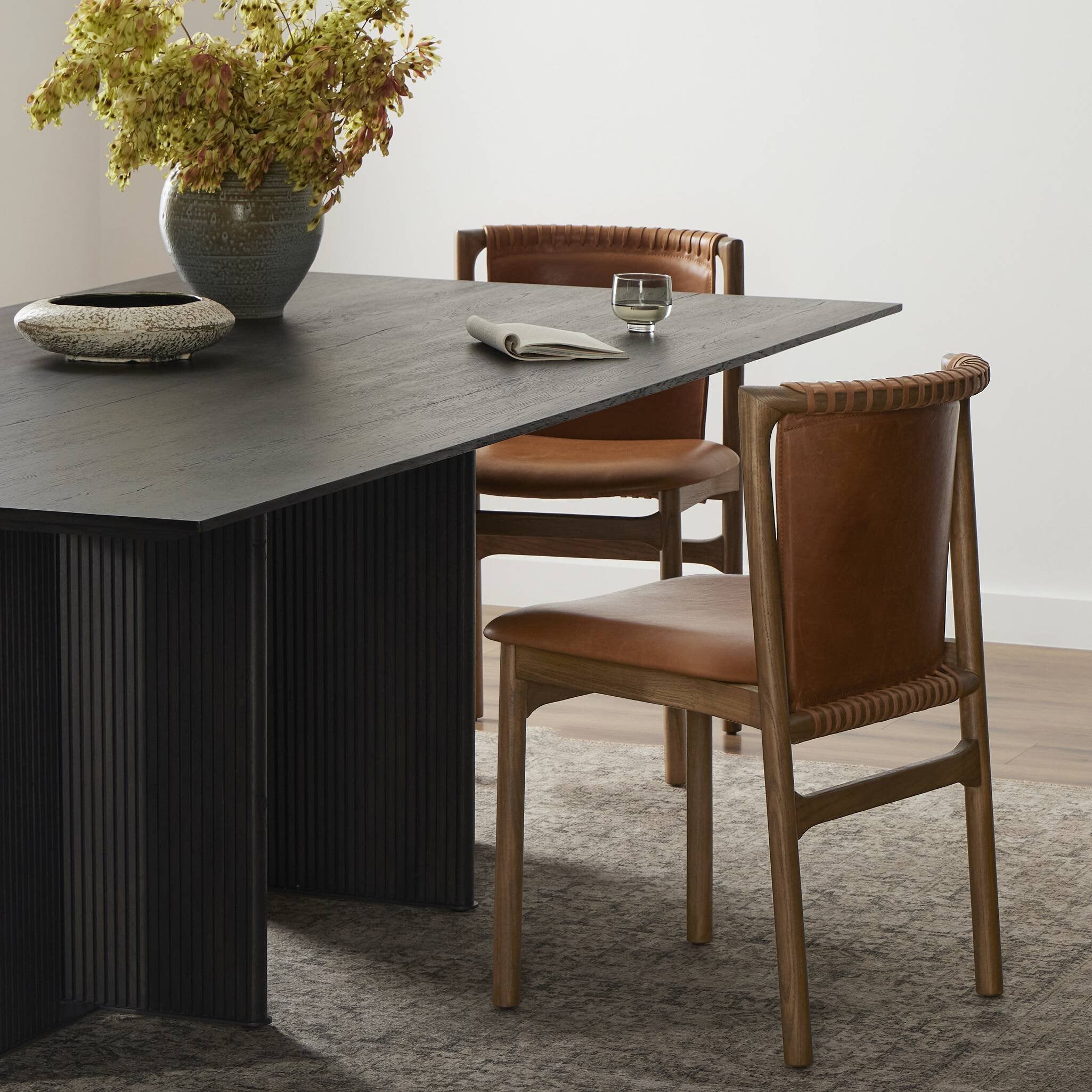 Dining table with brown chairs in a room setting