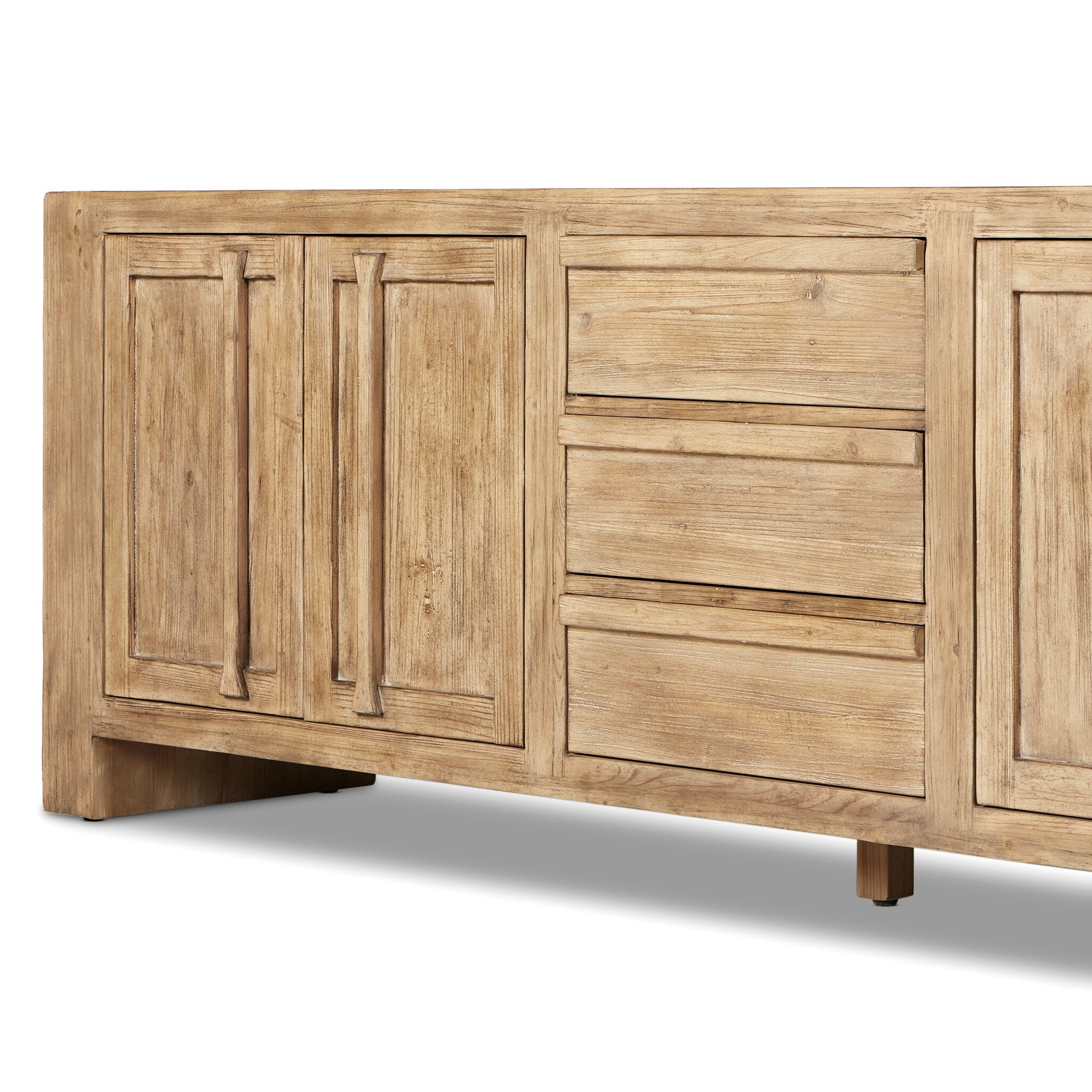 Wooden sideboard with four doors and three drawers in the center on a white background.
