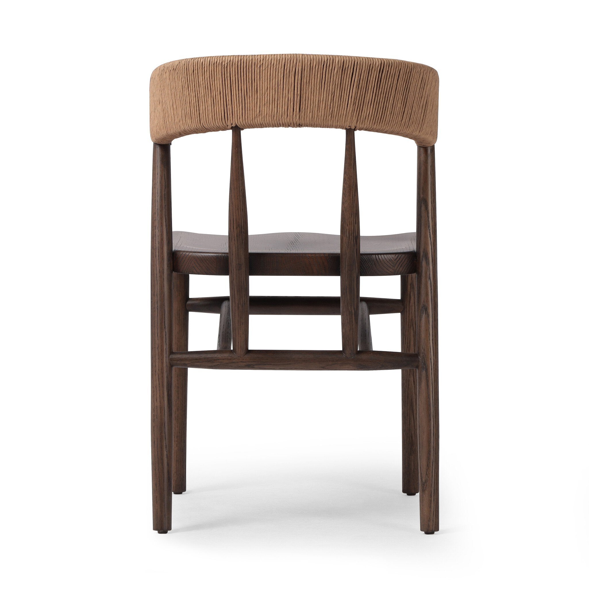 The back of a solid oak dining chair with tapered legs and a woven backrest on a white background.