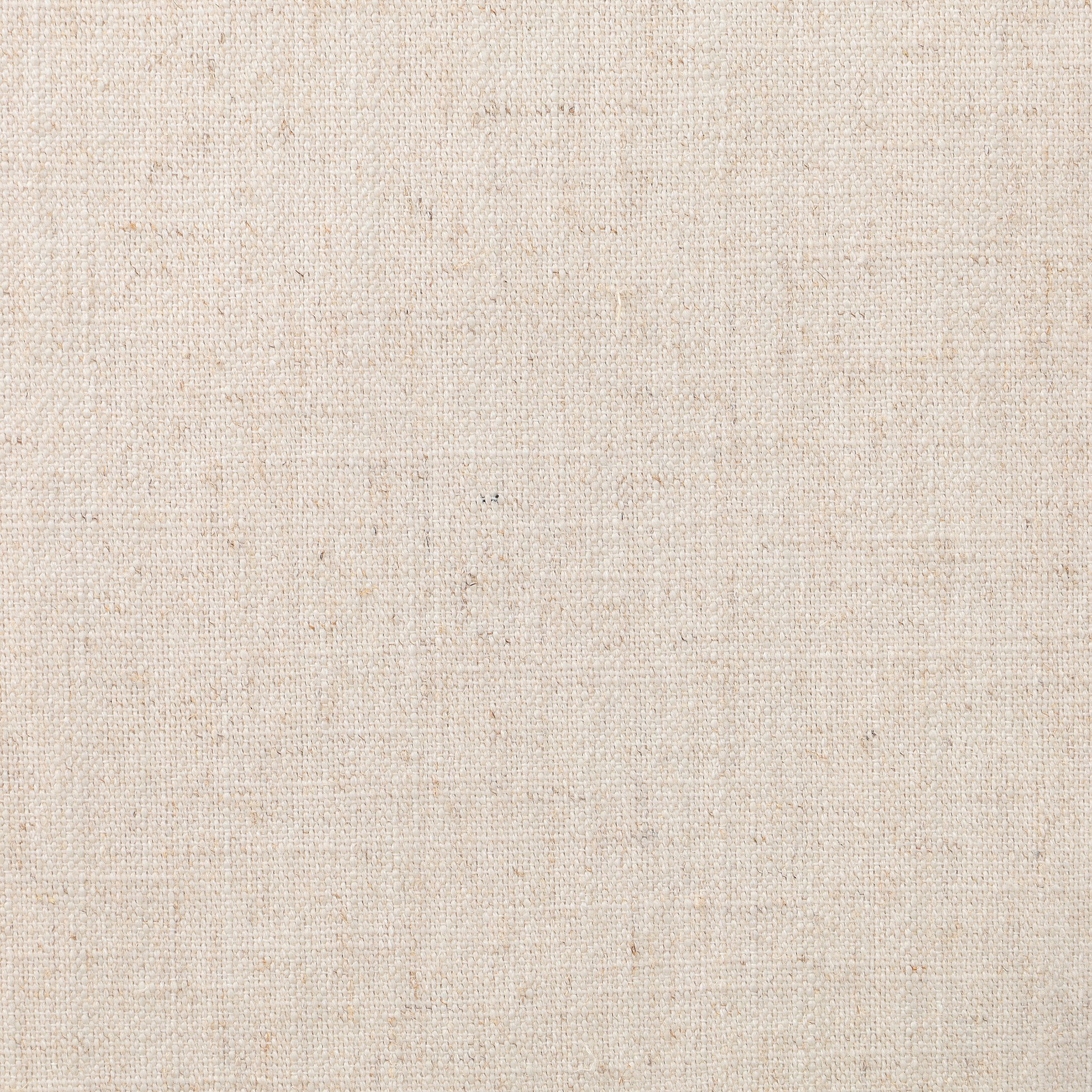 Close up of a solid oak dining chair with tapered legs, a woven backrest, and natural color seat cushion on a white background.