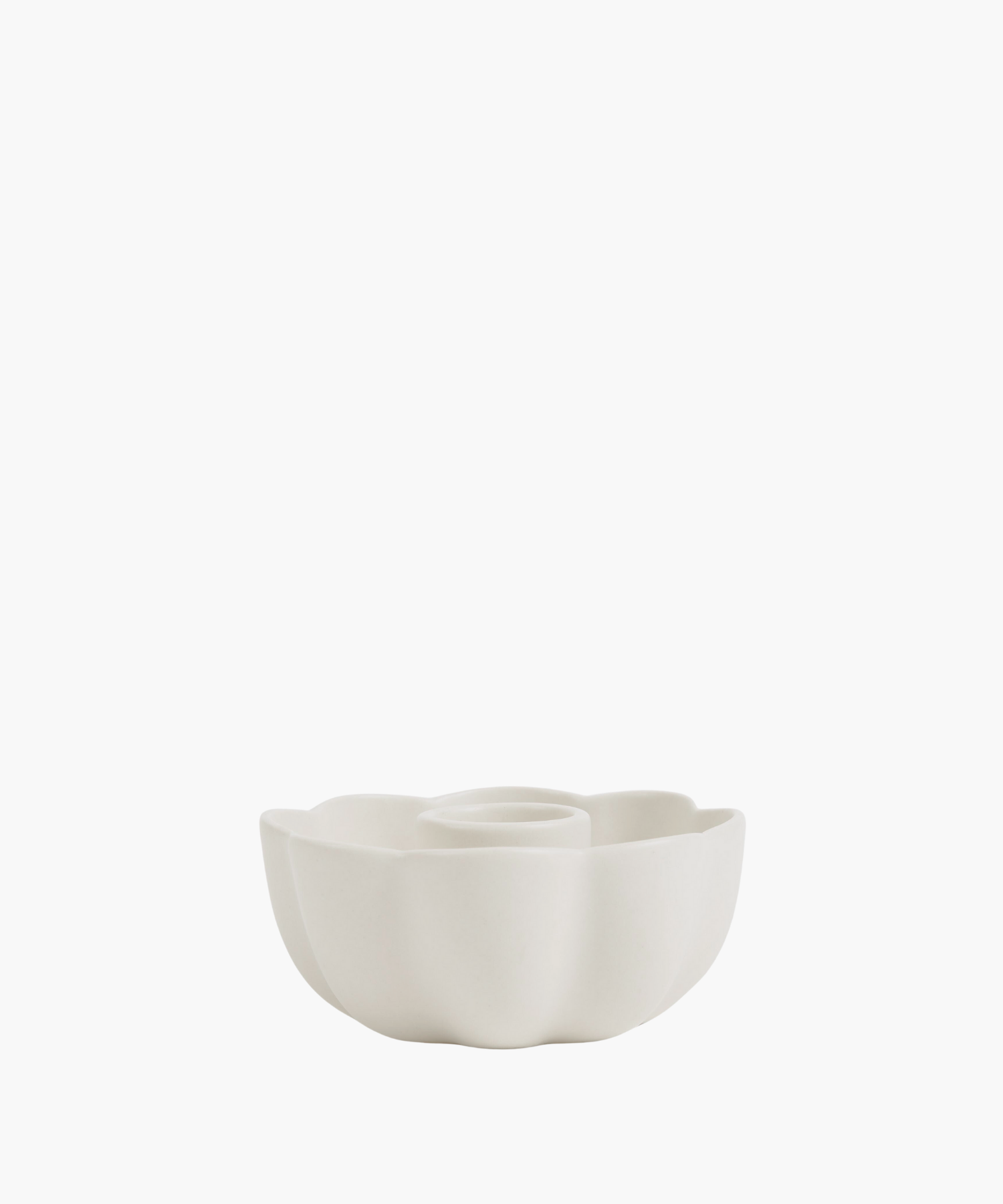 A smooth, matte white candle holder in floral shape. 
