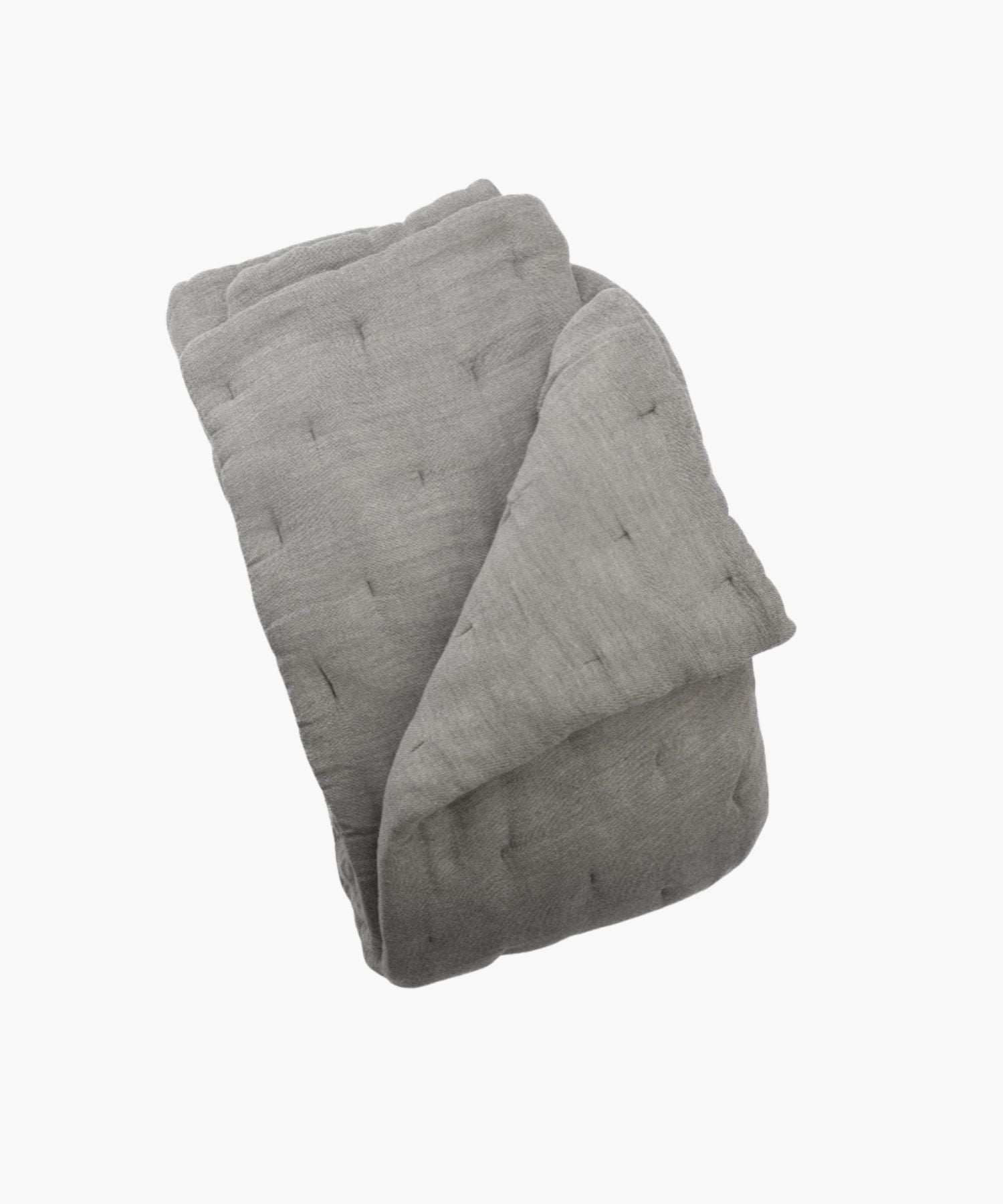 Folded gray quilt on a white background showing its fabric texture.