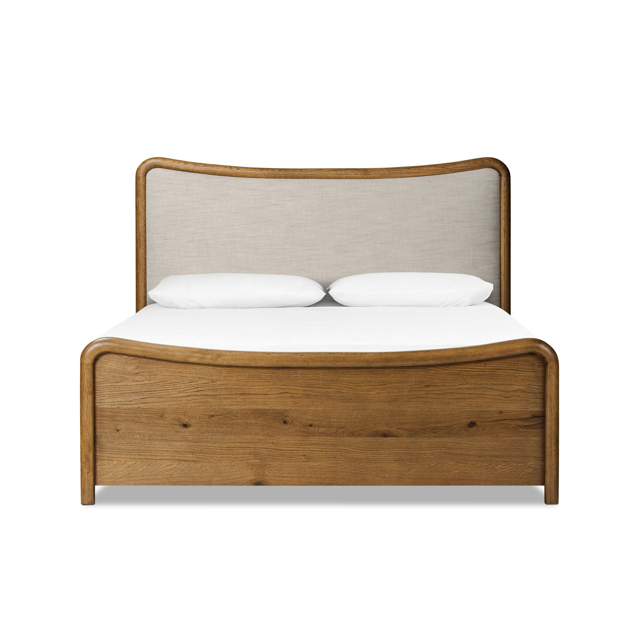 Heritage-inspired oak bed featuring soft curves, linen upholstered headboard, and white bedding on a white background. 