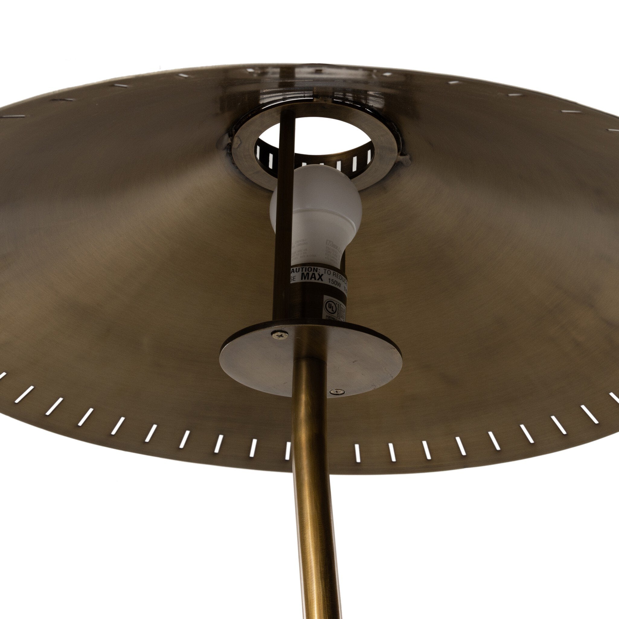 Close-up of a floor lamp with an antique brass shade and bulb.