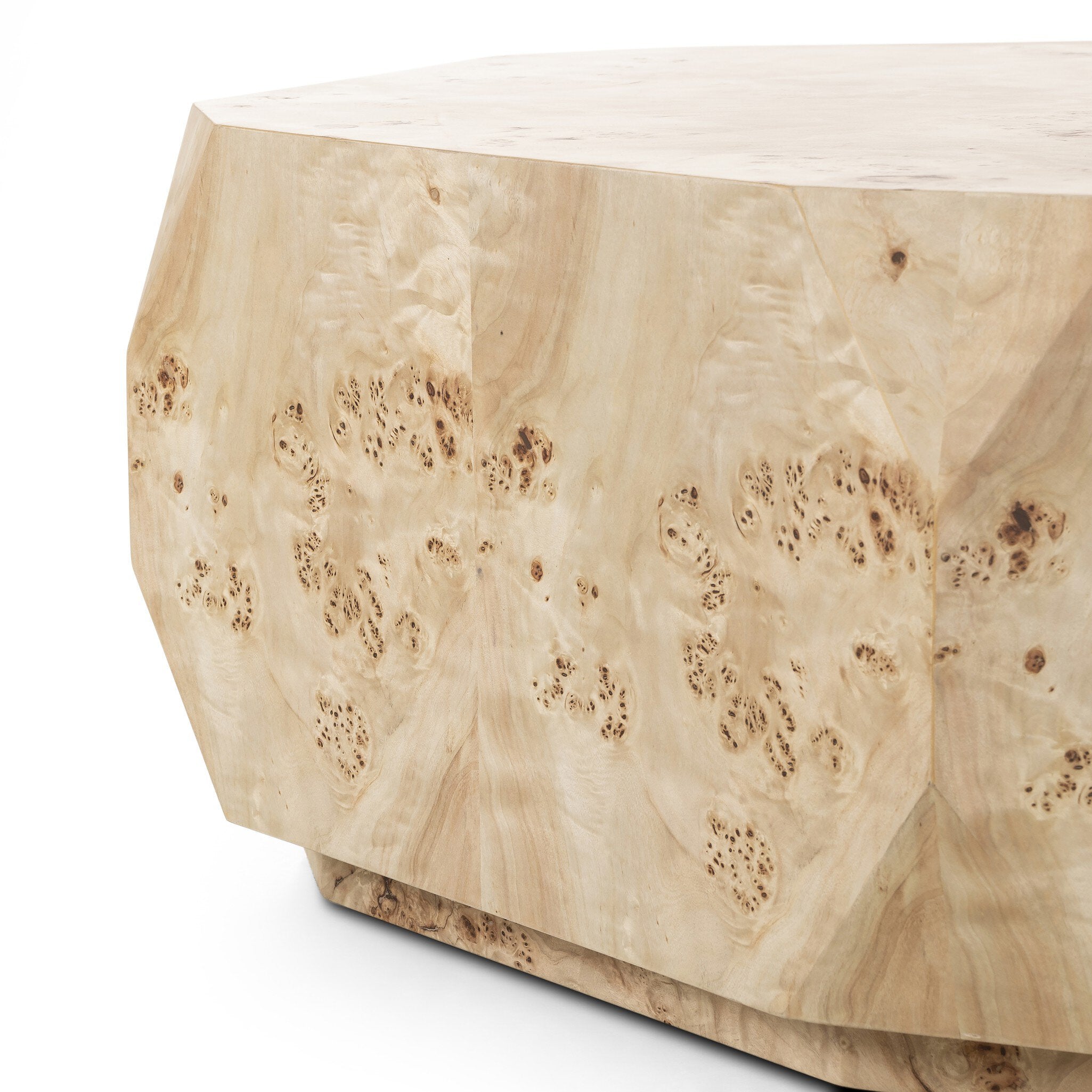 Close up of an organic-looking shaped coffee table with a natural finish on a white background.