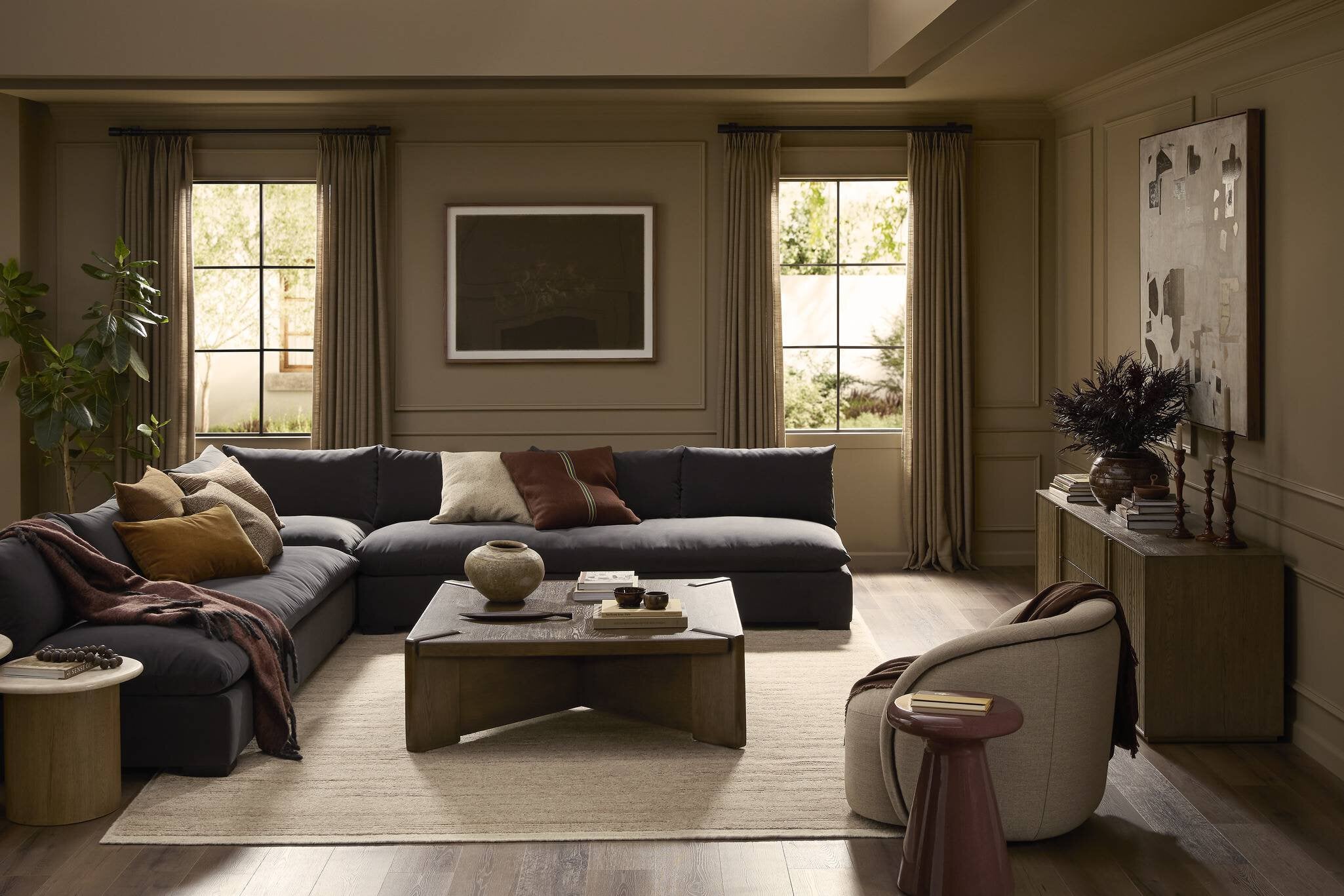 Modern living room with a sectional sofa, coffee table, and decorative items.