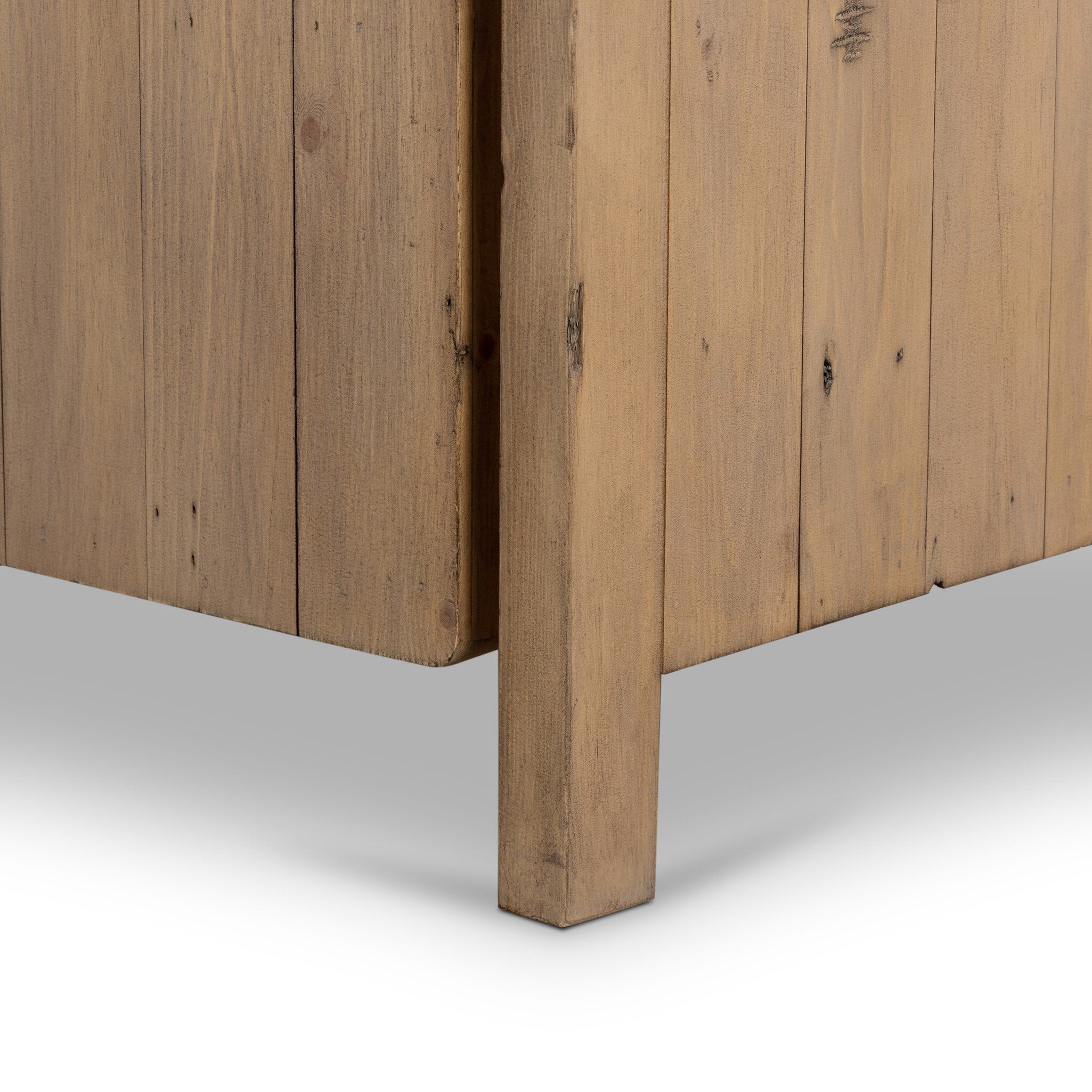 Close up of a wooden cabinet with two doors and rounded corners on a white background.