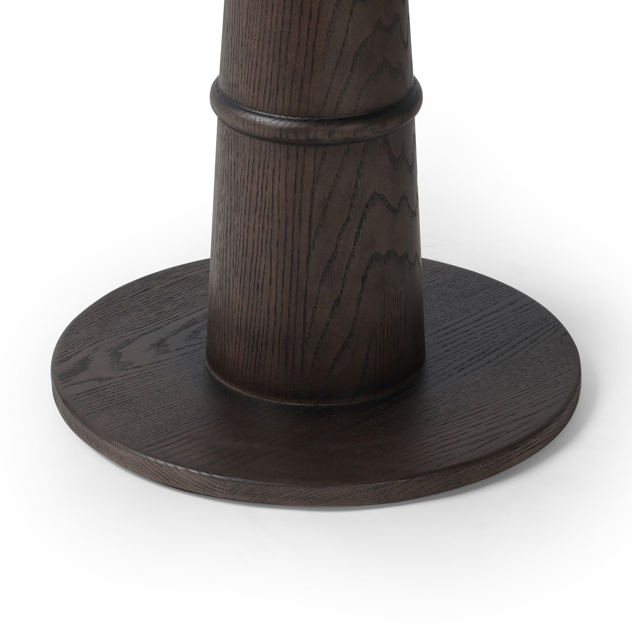 Close up of a dark wooden round cocktail style table on a white background.