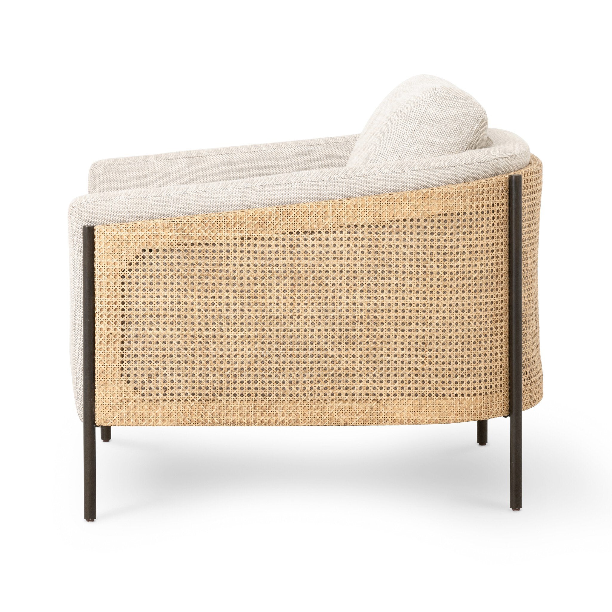 Side profile of a beige armchair with dark metal legs on a white background.