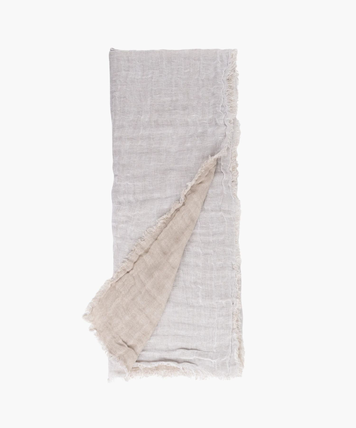 Flat lay of the Kent Super Throw in natural white linen tone, highlighting its oversized linen gauze texture and soft fringed edges.