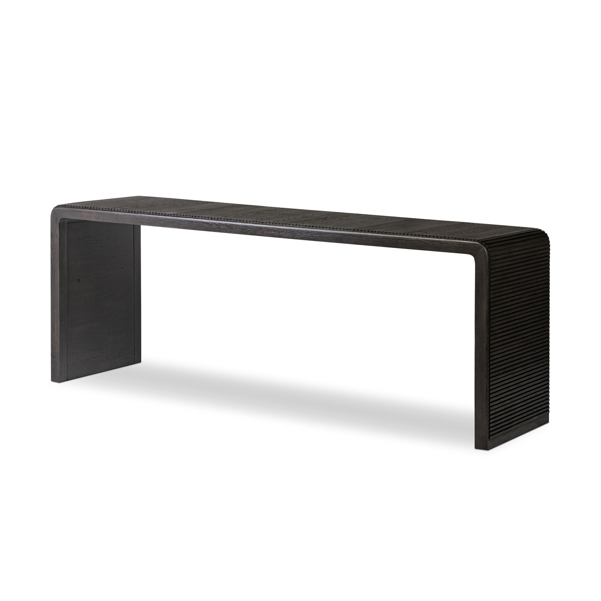 Smoked black oak console table with reeding and rounded edges on a white background.