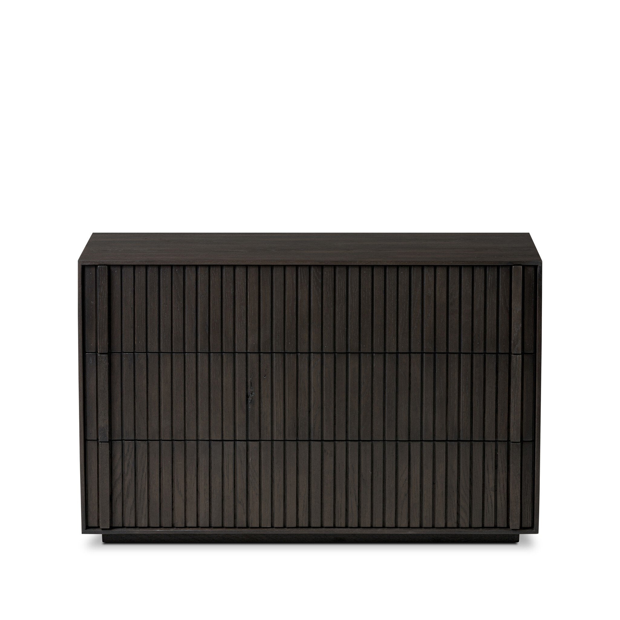 Dark wooden dresser with vertical reed detailing and three drawers on a white background.
