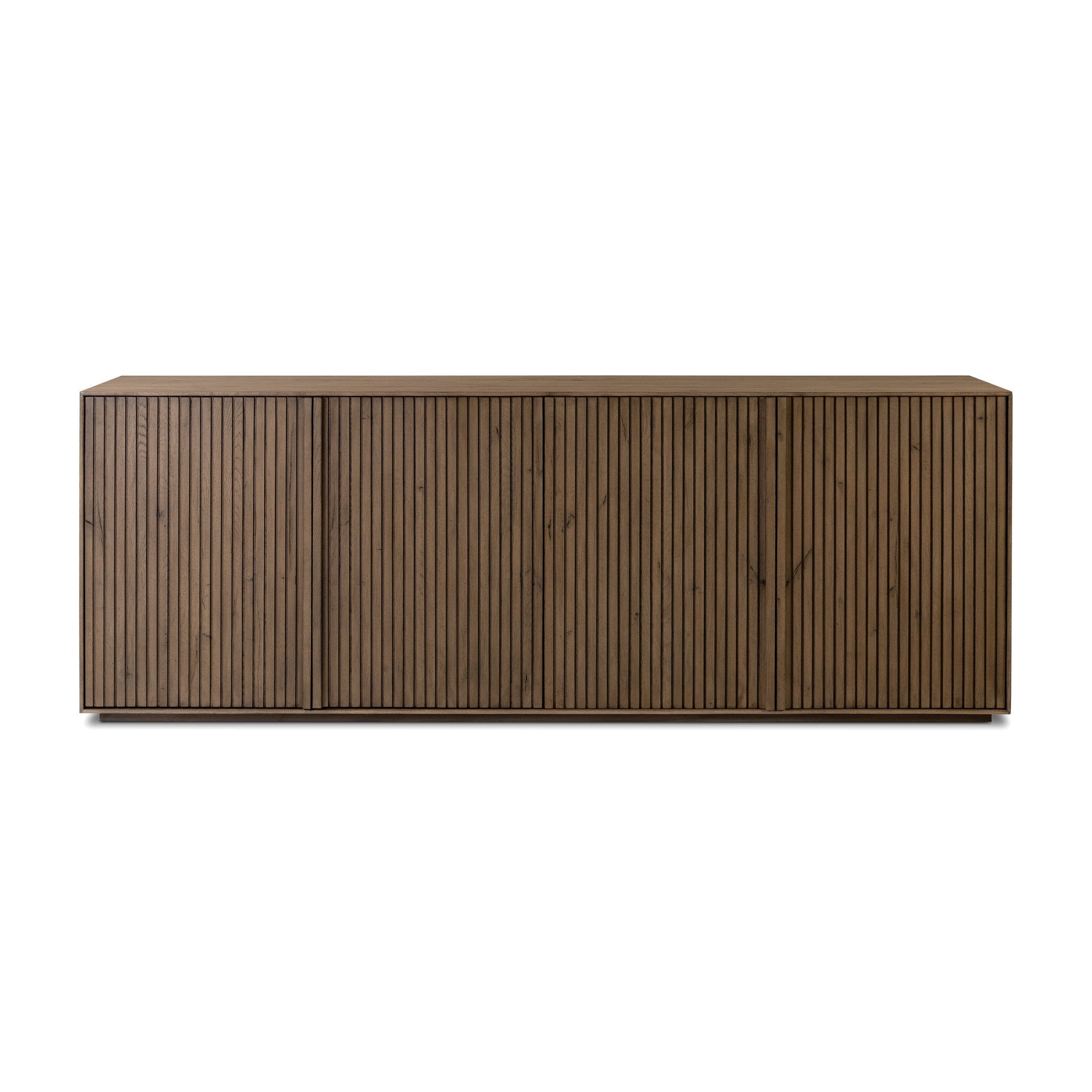 Wooden sideboard with vertical reeding on a white background.