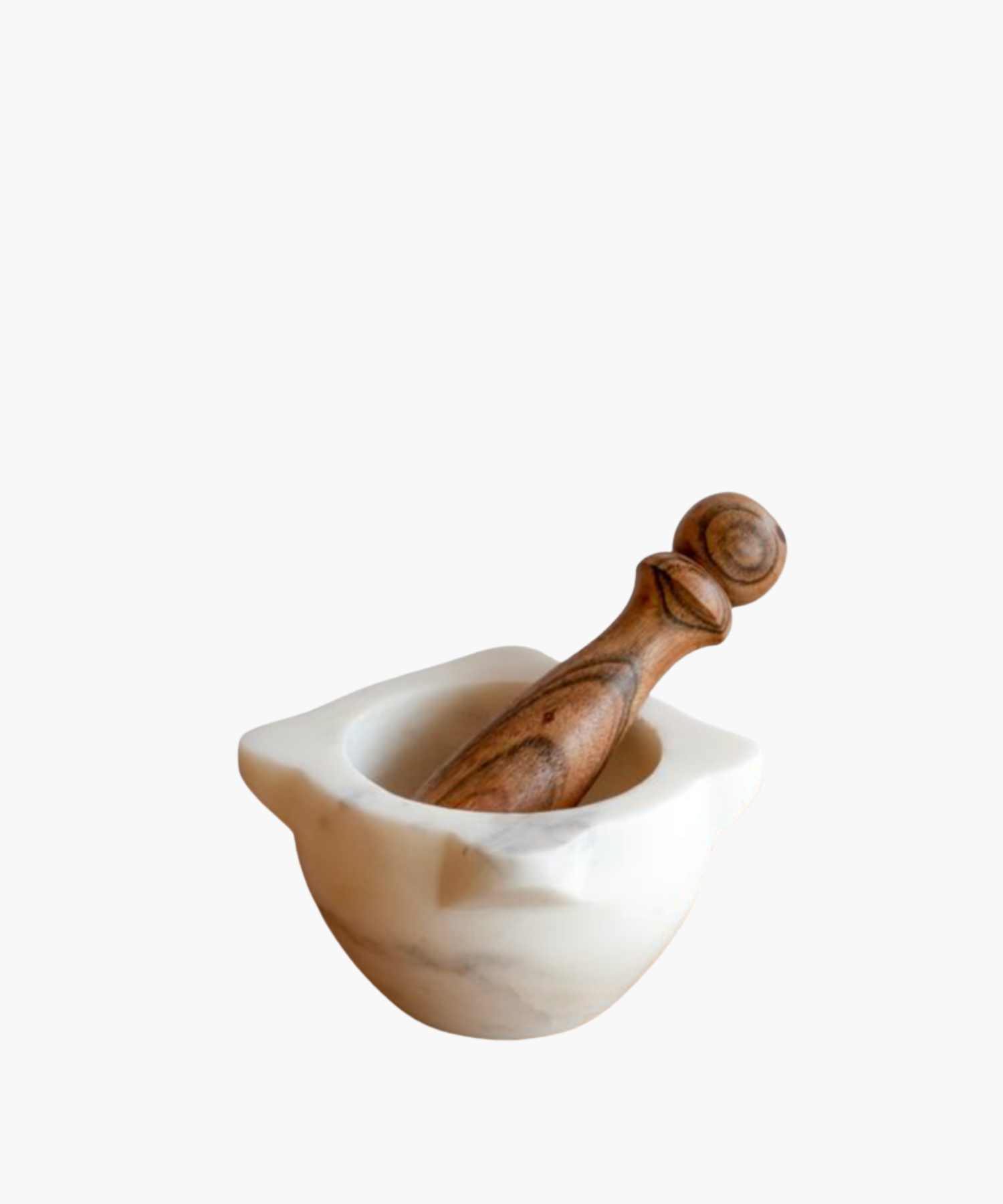 A marble mortar with a wooden pestle resting inside. The mortar is smooth and white, contrasting with the textured, brown wood of the pestle.