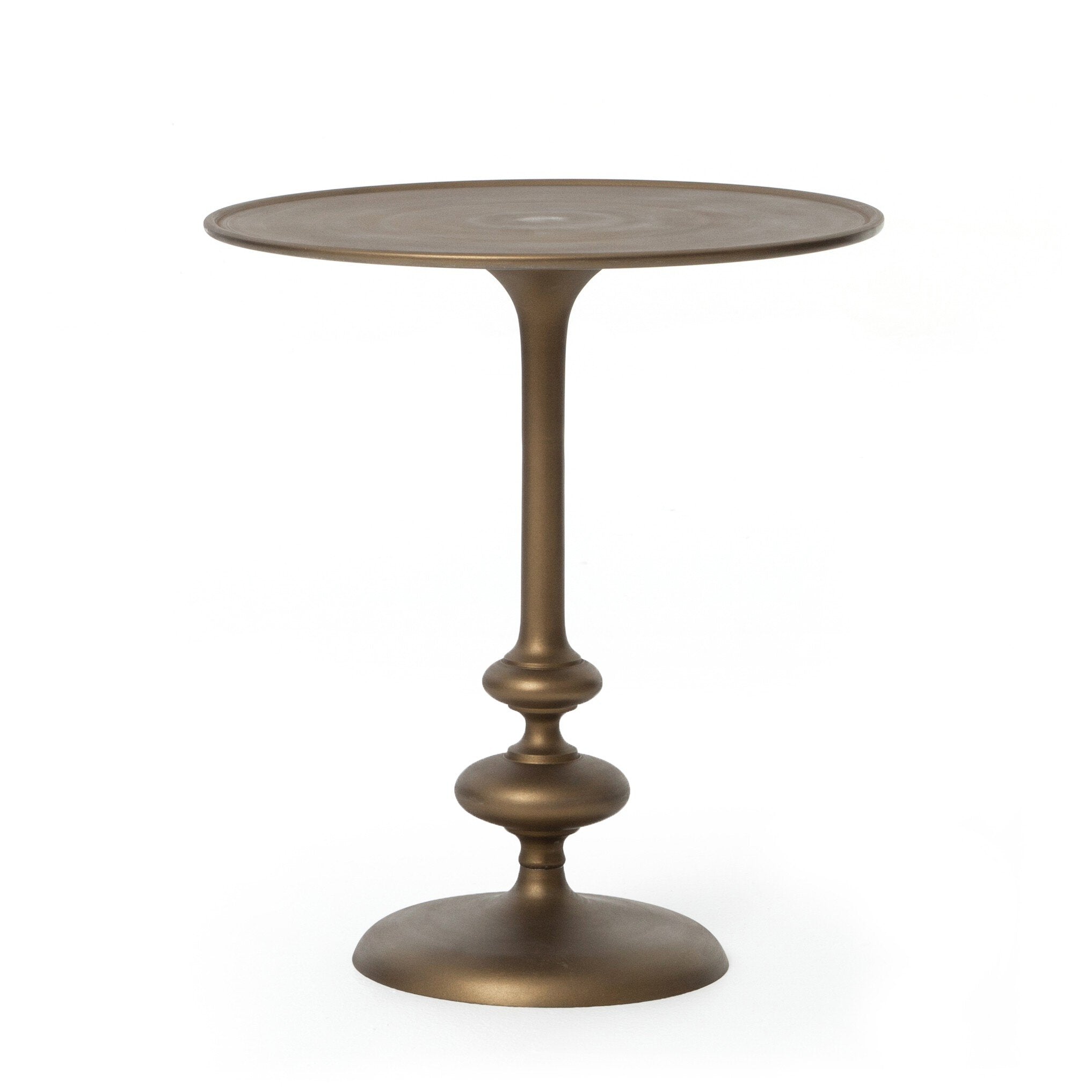 Brass finished pedestal table on a white background.