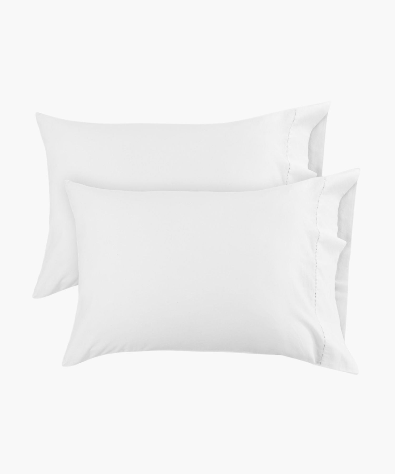 Standard white pillowcases shown in a flat lay against a white background, with a hemstitch detail near the edge adding a subtle, tailored finish.
