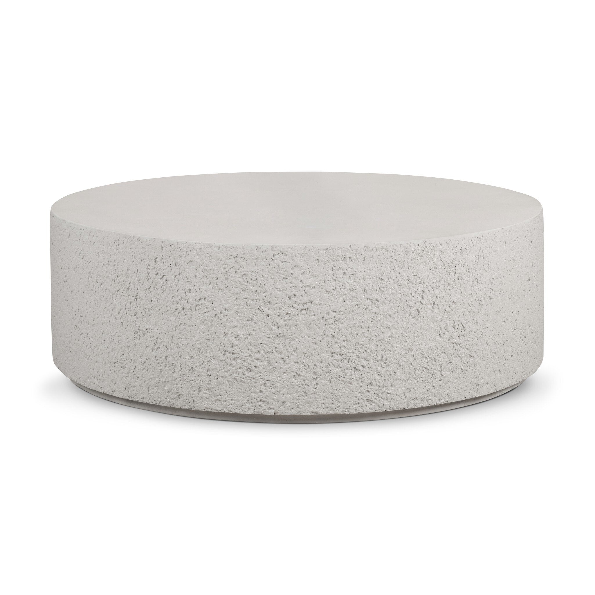 Round concrete coffee table with raw edges and a smooth top on a white background.
