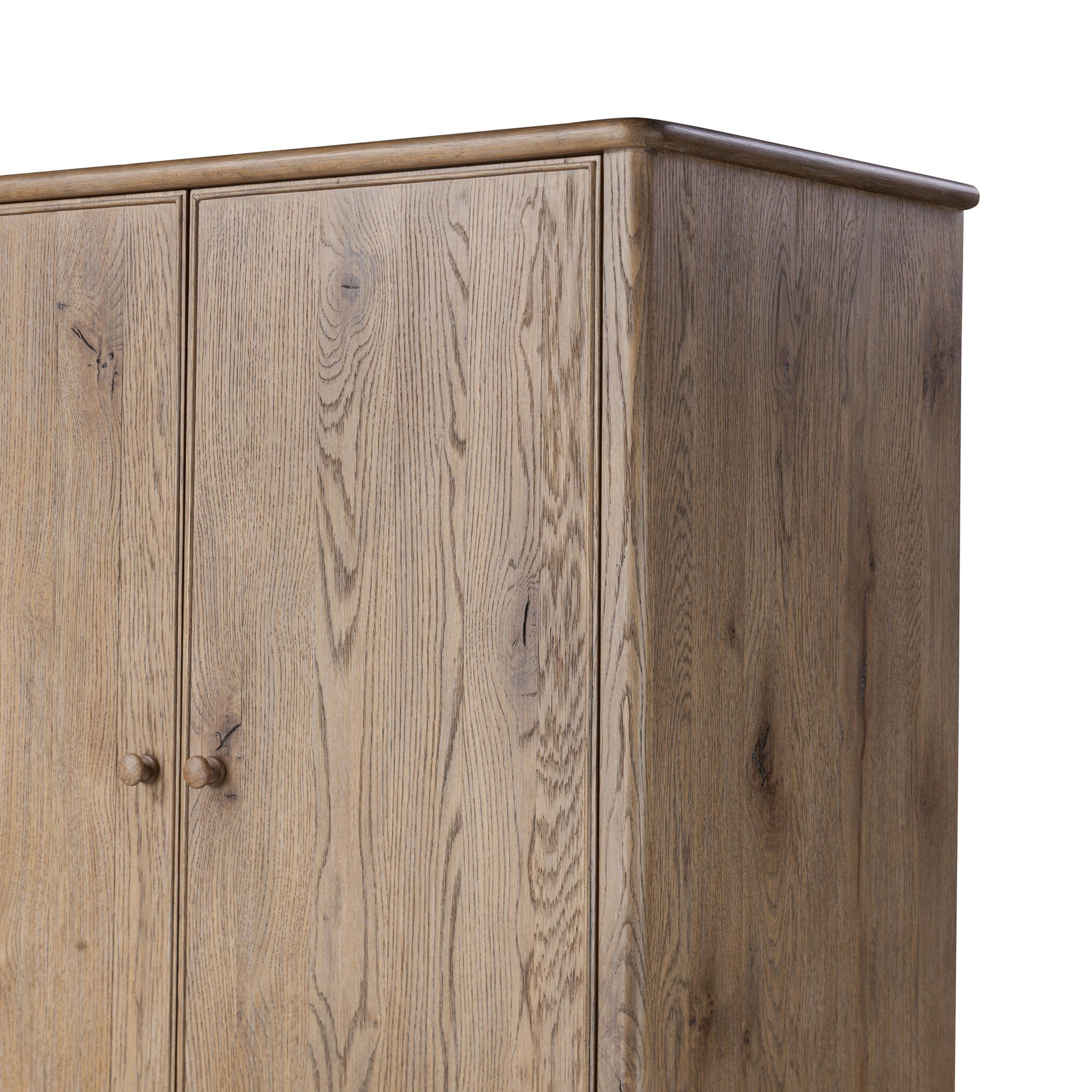 Close up of a wooden armoire with two doors and four drawers on a white background.