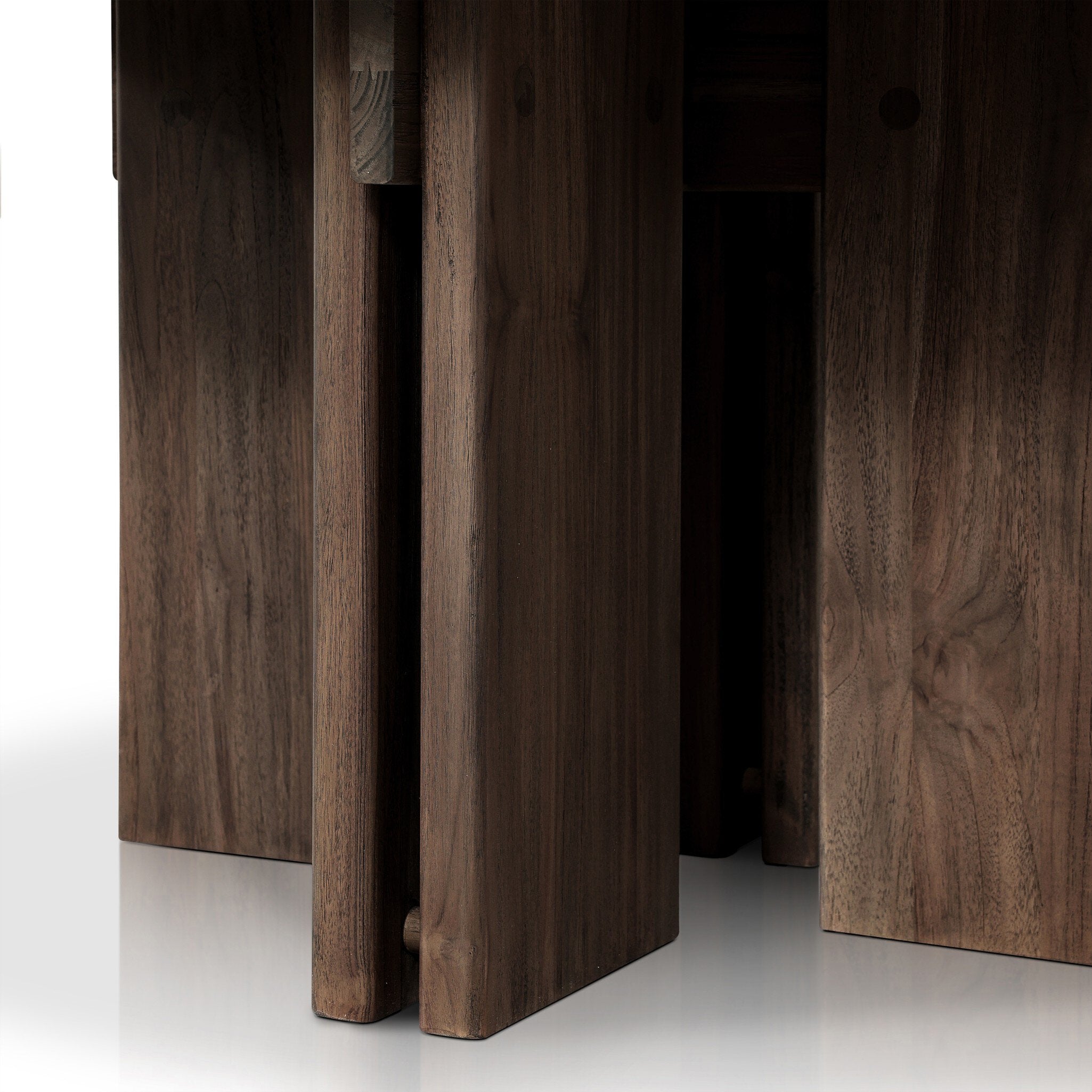 Close up of a Solid teak round dining table showing its linear joints and connection details. 