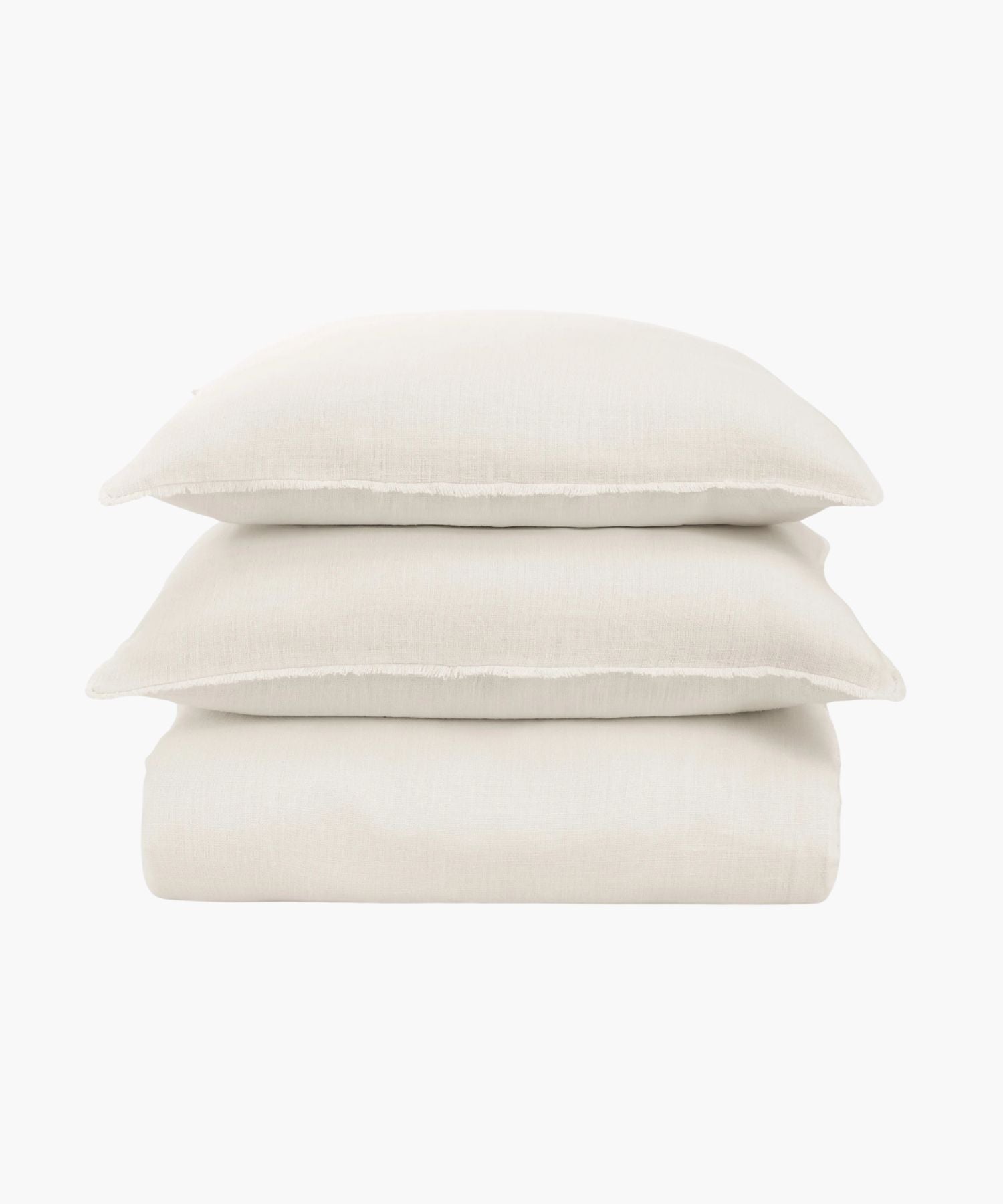 Stack of ivory bedding sheets and pillows on a white background