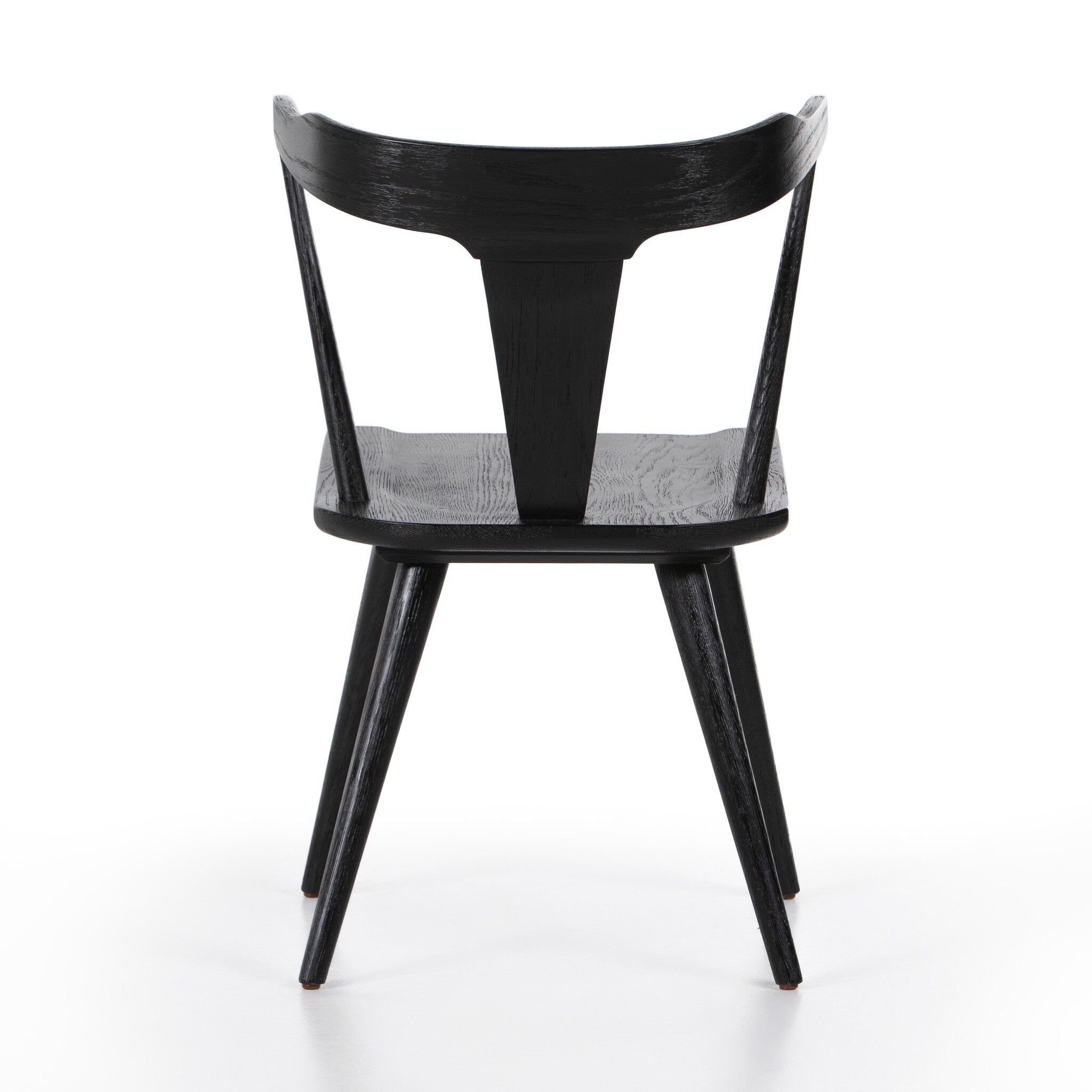 The back of a black wooden dining chair on a white background.
