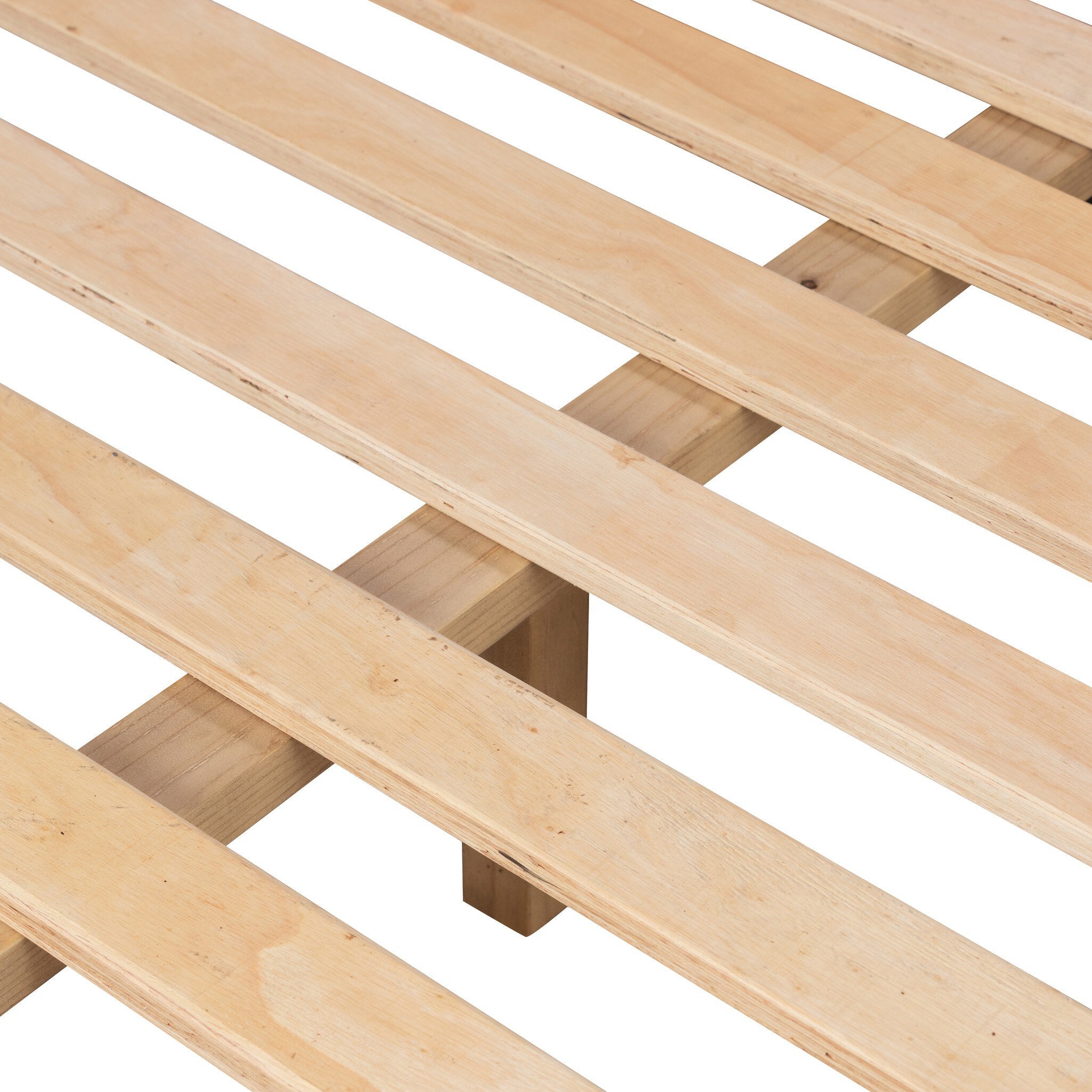 Close up of a wooden bed with upholstered headboard and white bedding on a white background.