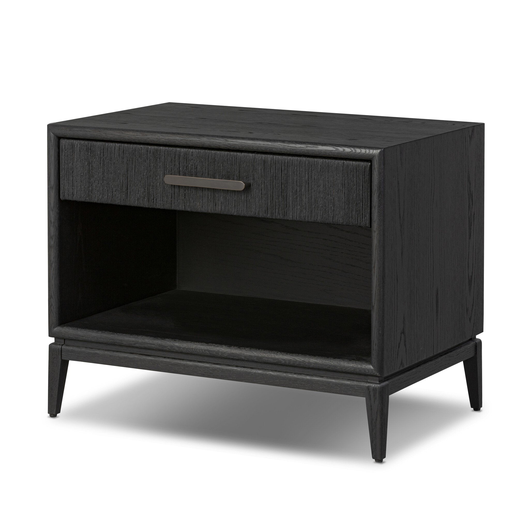 A black-finished oak nightstand with a smooth top and single drawer front of woven paper on a white background. 