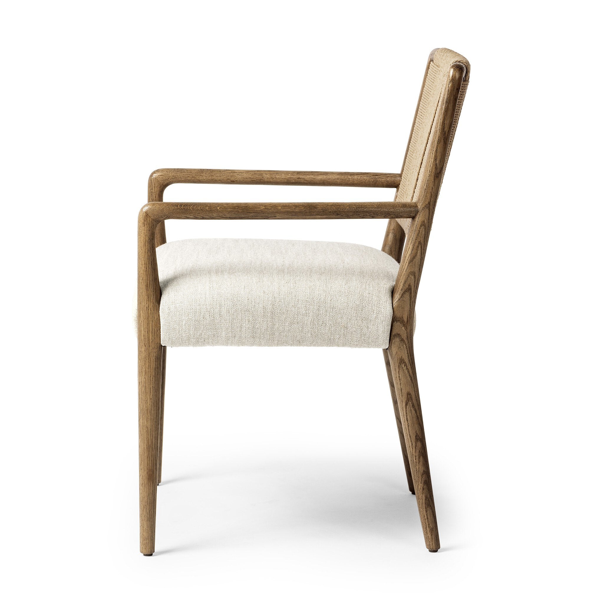 Side profile of a dining chair with woven backrest and upholstered seat on a white background.