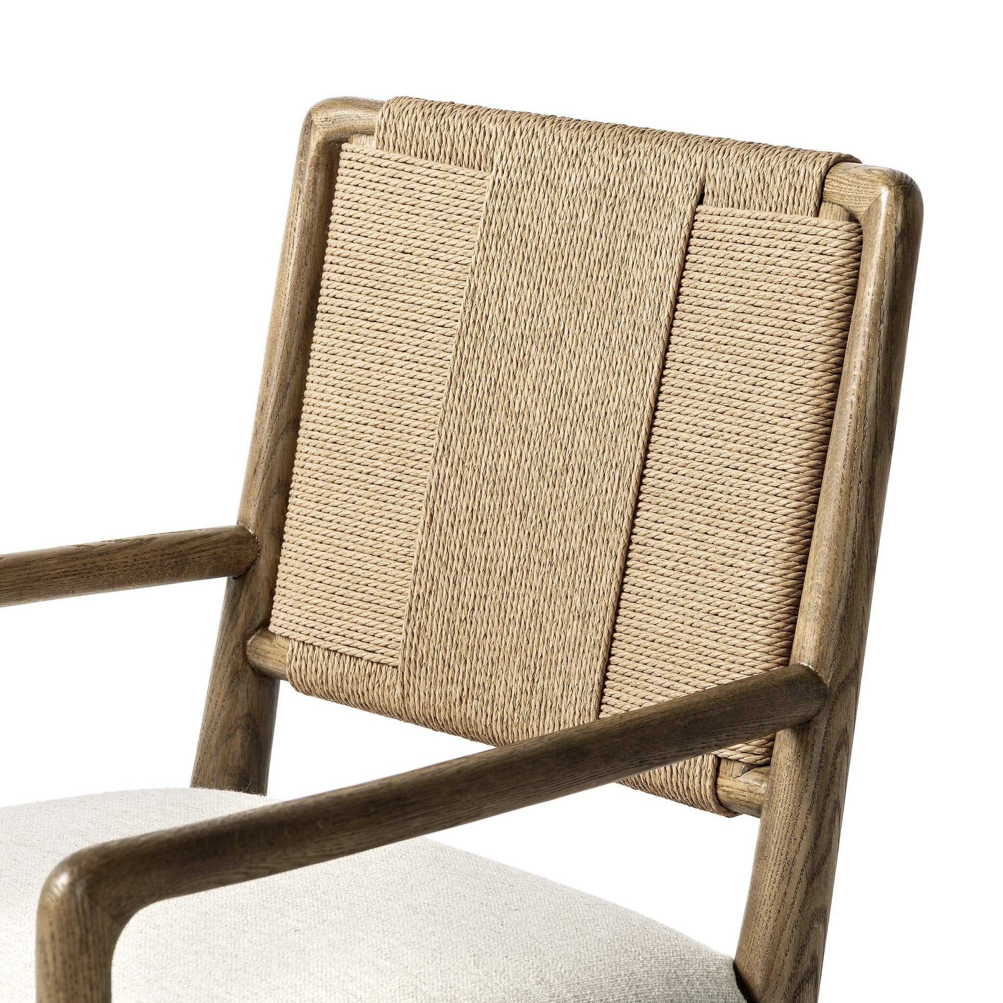 Dining chair with woven backrest and upholstered seat on a white background.