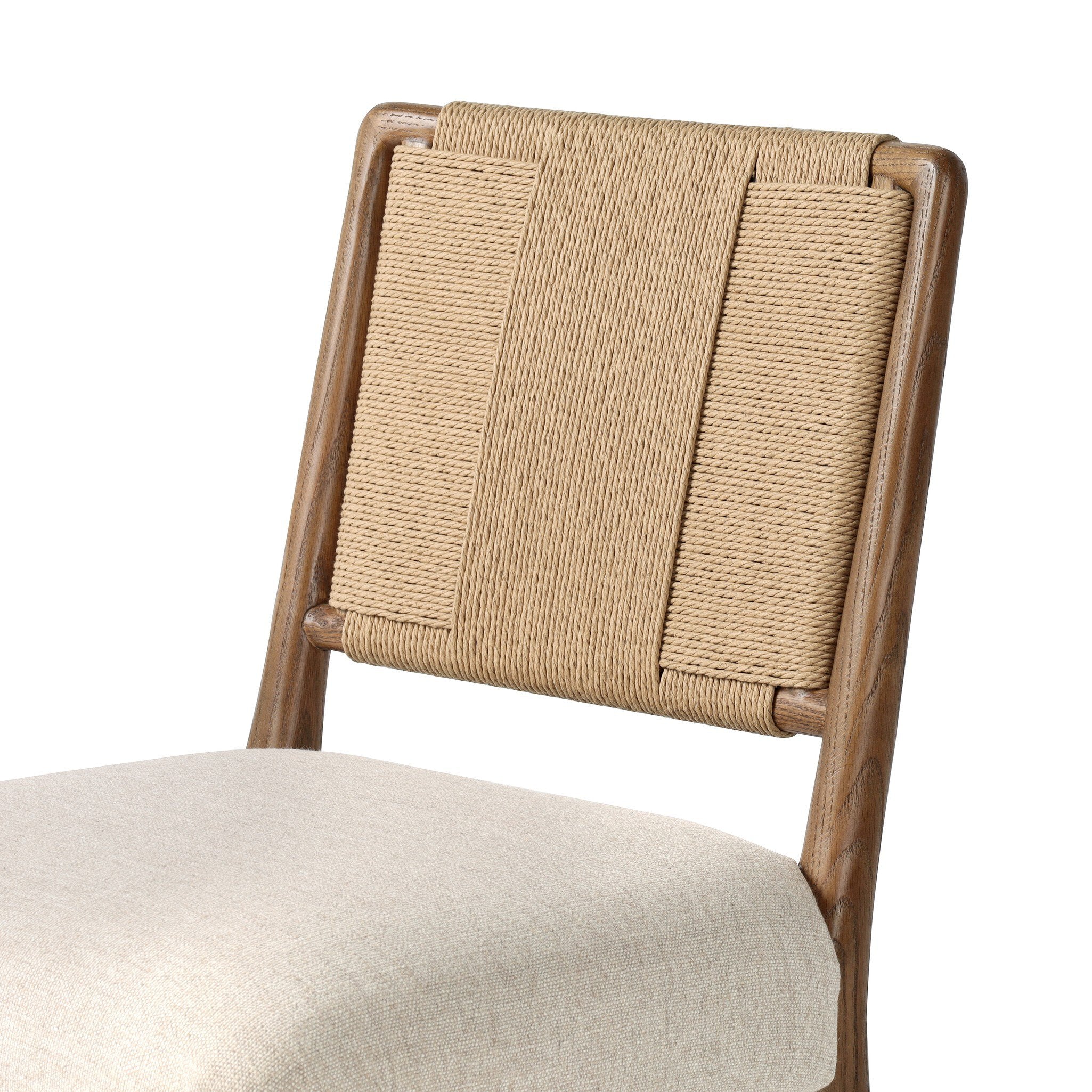 Dining chair with woven backrest and beige cushion on a white background.