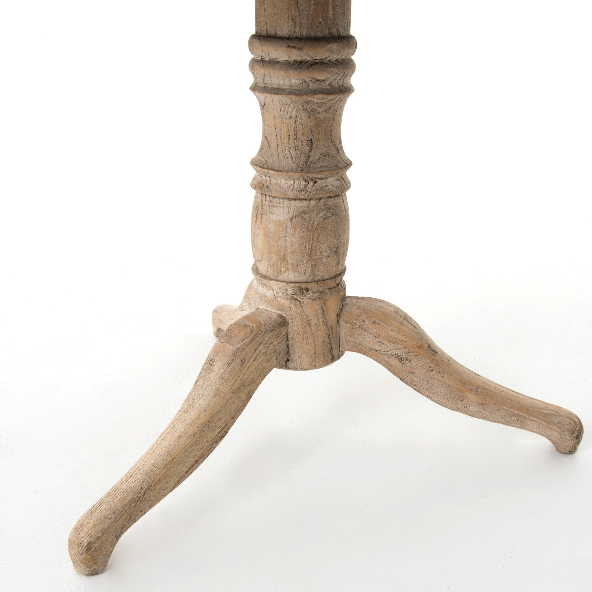 Close up picture of the turned pedestal and curved tripod feet on a white background feet.