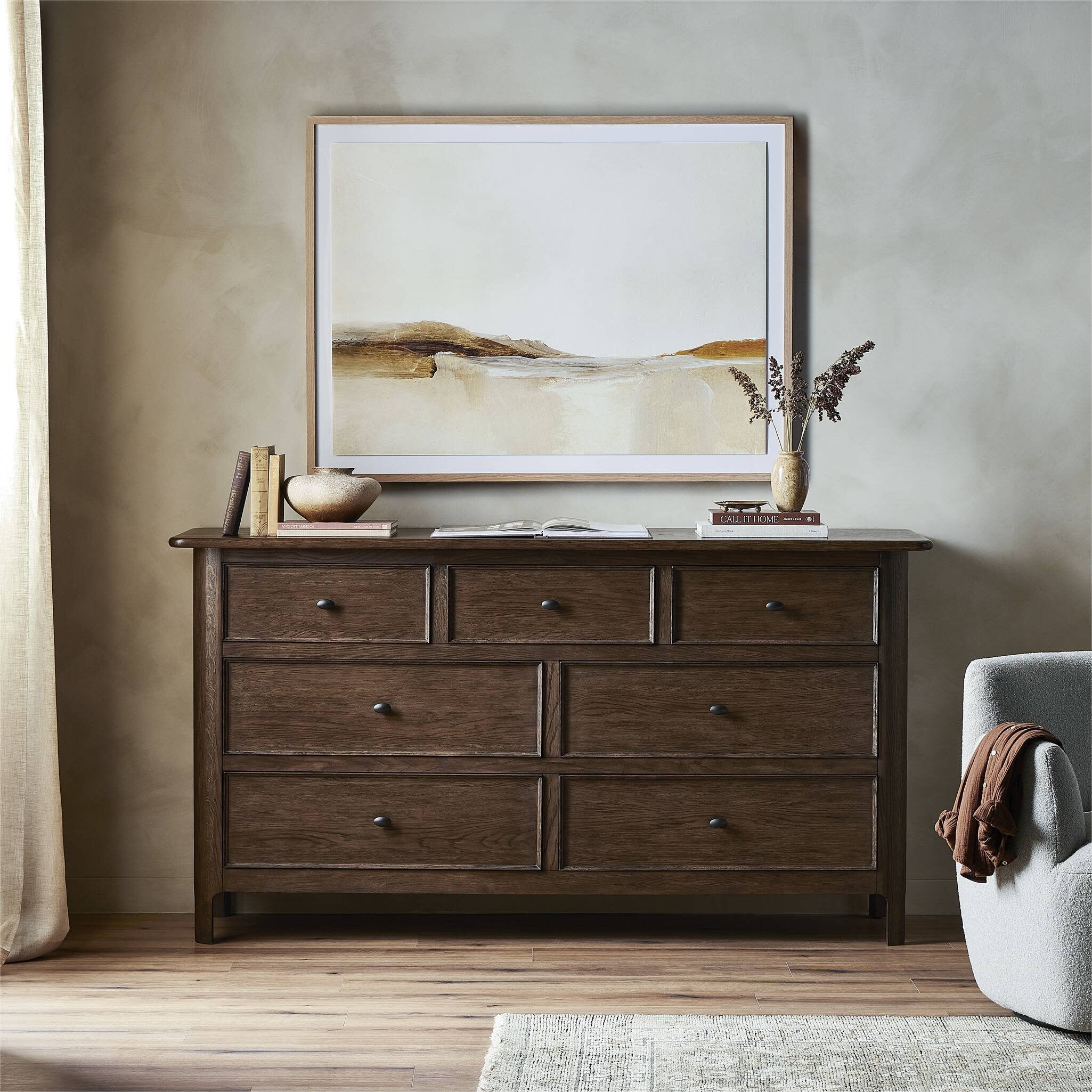 Wooden dresser with decorative items in a room setting