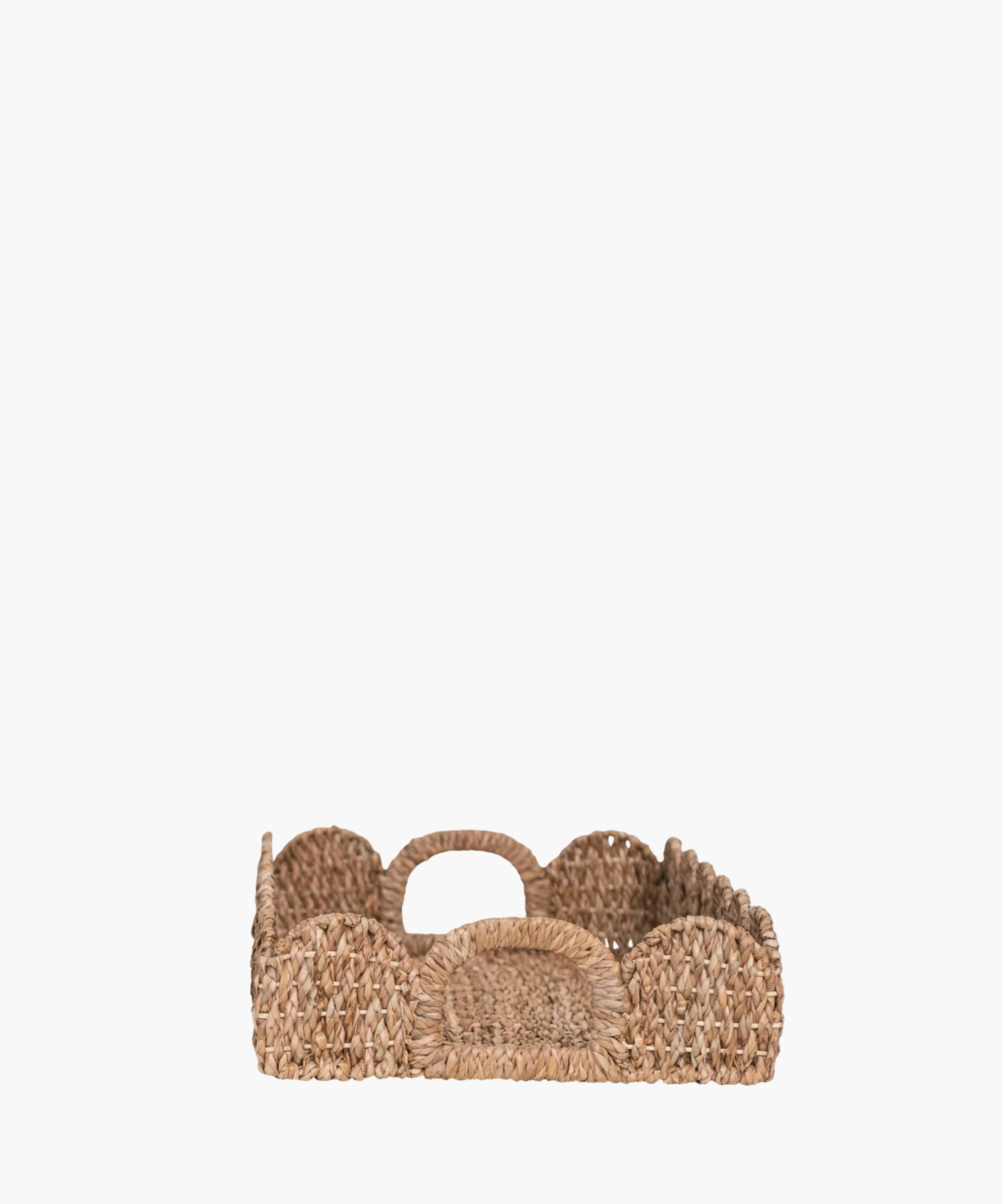 A side profile picture of rectangular woven tray with scalloped edges highlighting the curved handle. The natural brown hue adds a rustic, earthy charm.