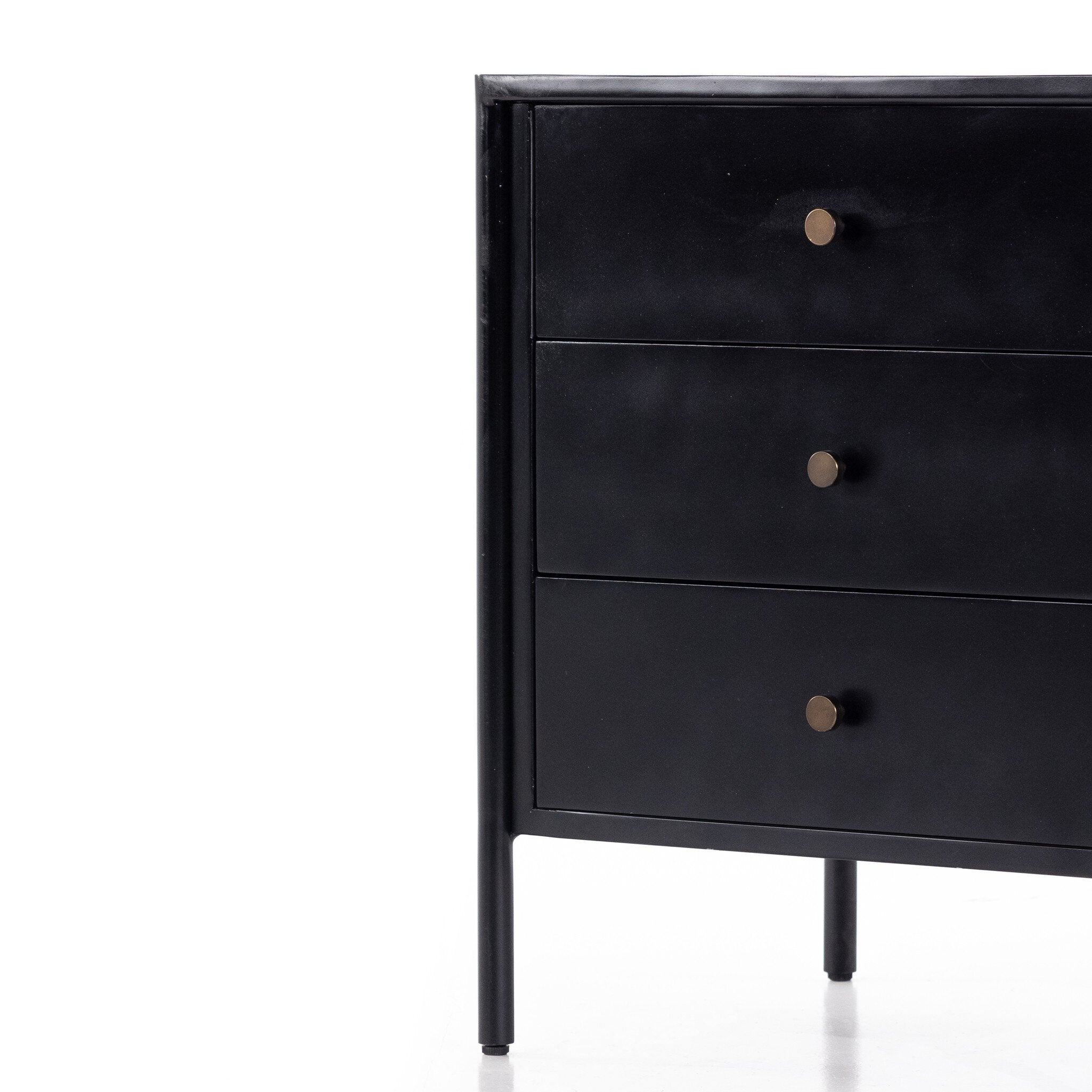 The back of a black dresser with three drawers on a white background.
