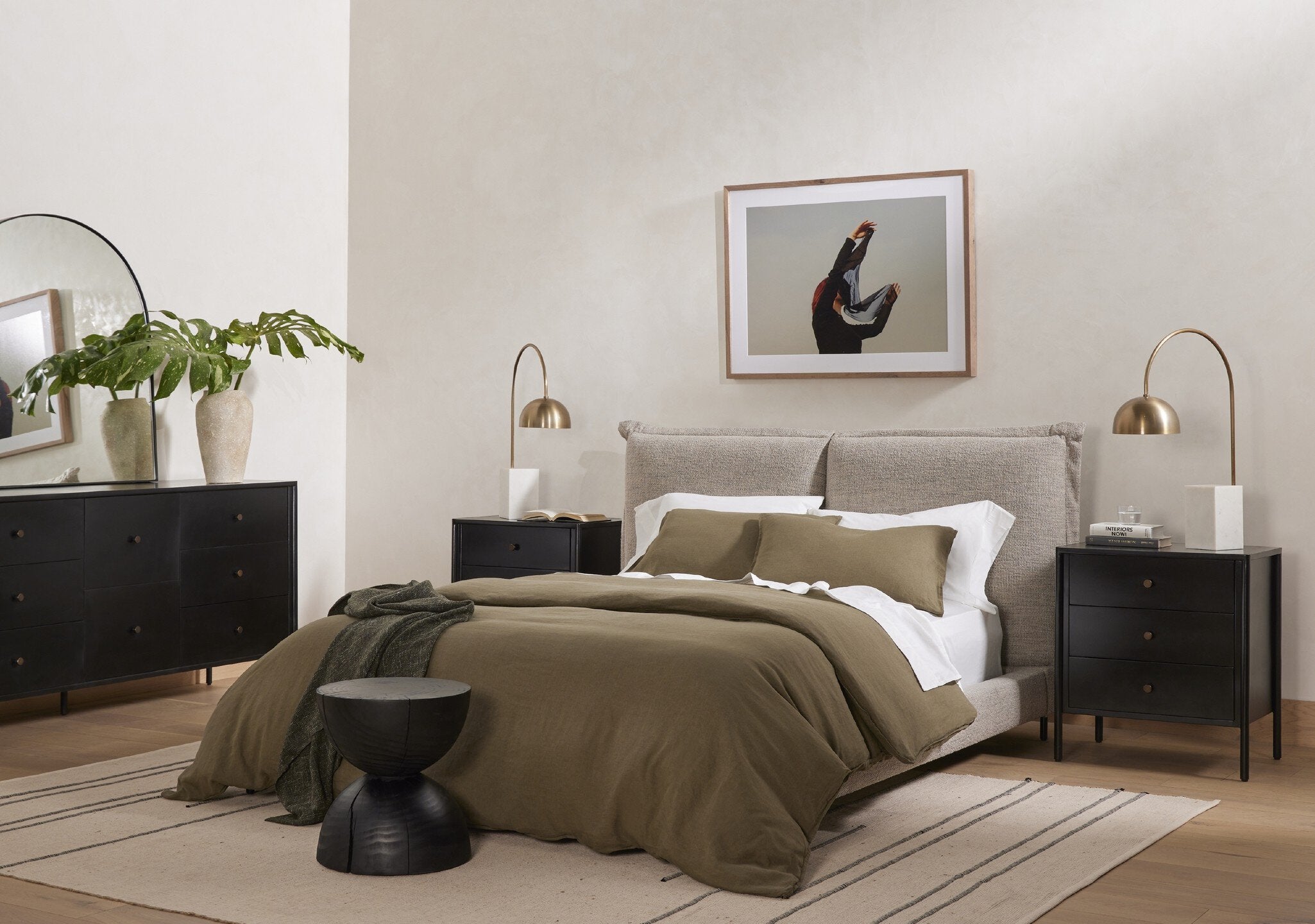 Modern bedroom with a bed, nightstands, and decor elements.