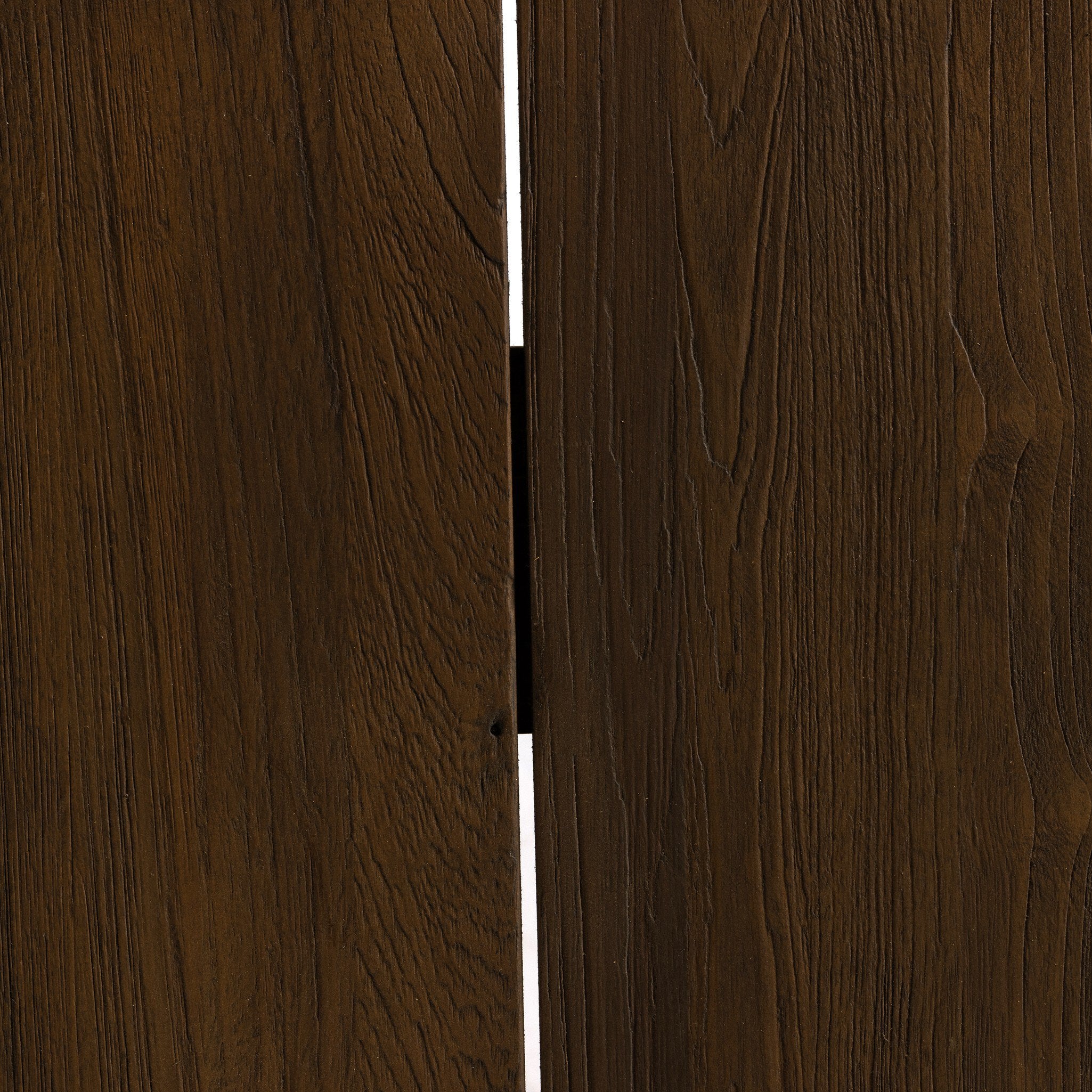 Close up view of a teak dining table showing its brown coloring and natural graining. 