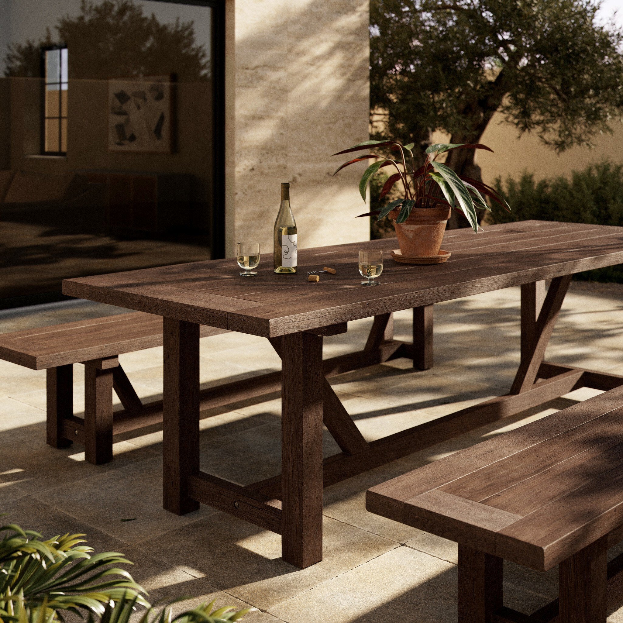Trestle-style dining table made from reclaimed teak on a white background.