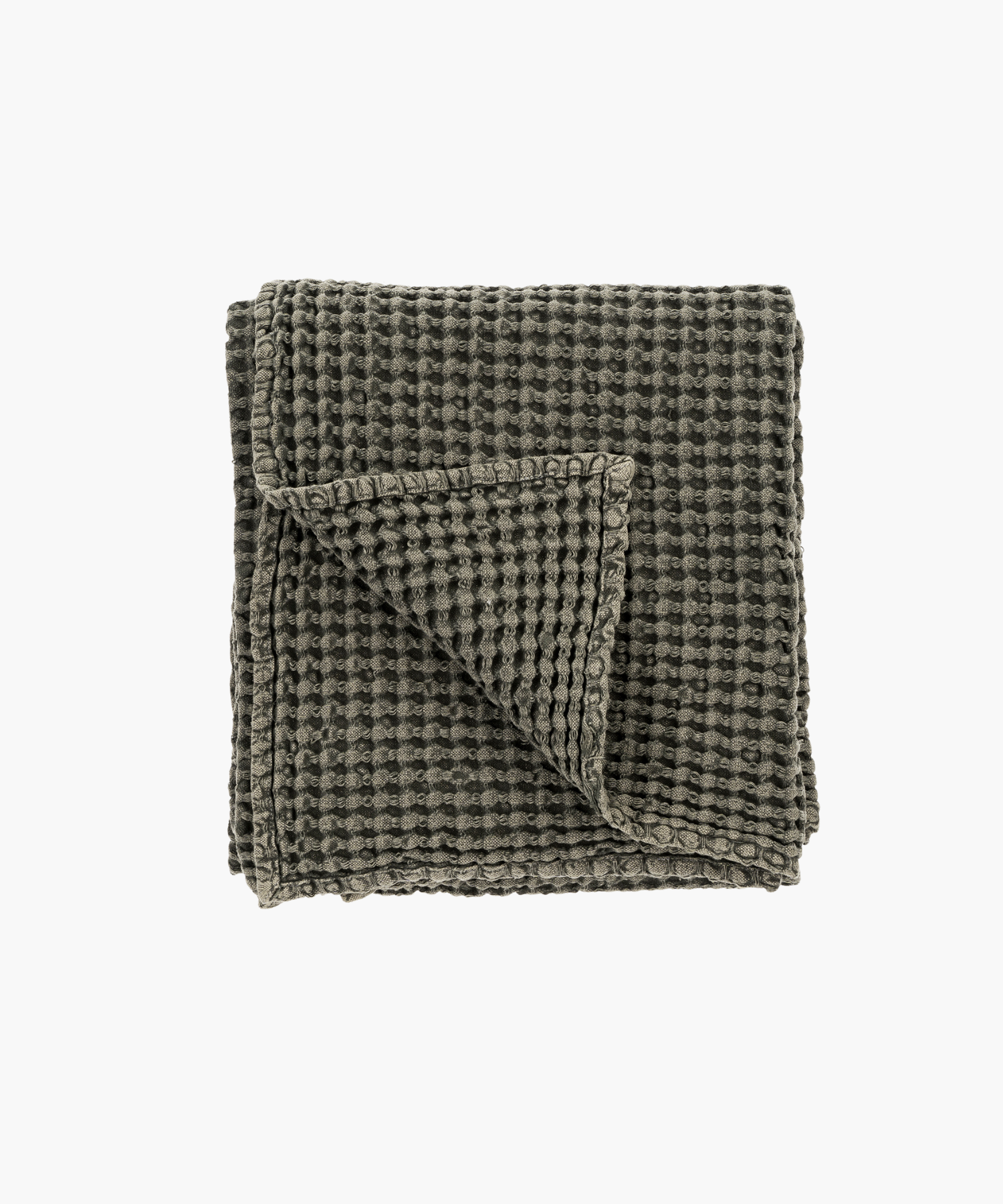 Dark gray or charcoal waffle weave throw blanket, neatly folded with one corner flipped over, showcasing its textured, cozy fabric on a plain white background.
