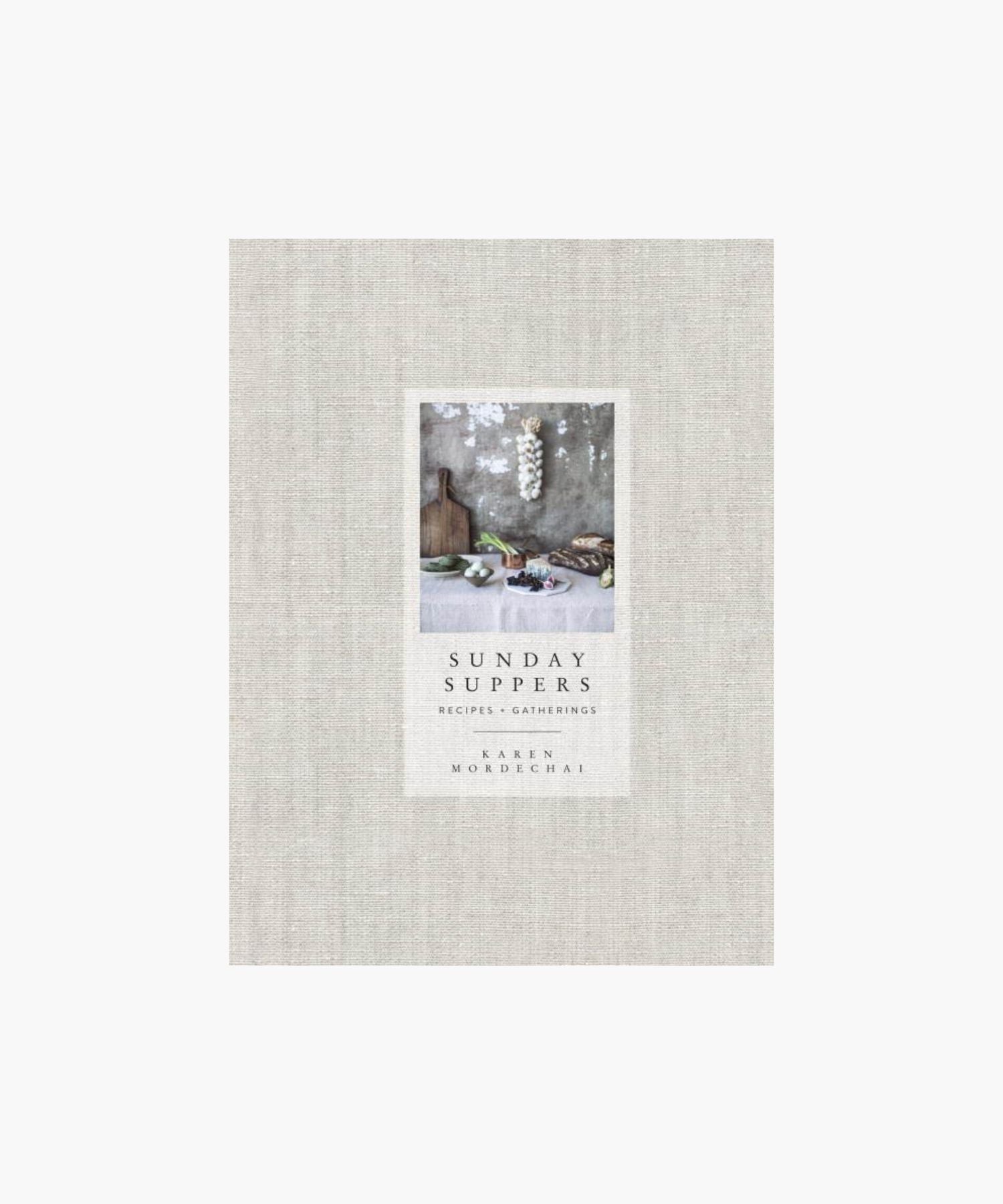 Cookbook cover titled "Sunday Suppers" by Karen Mordechai features rustic kitchen items on a table against a textured wall, evoking a cozy, inviting scene.