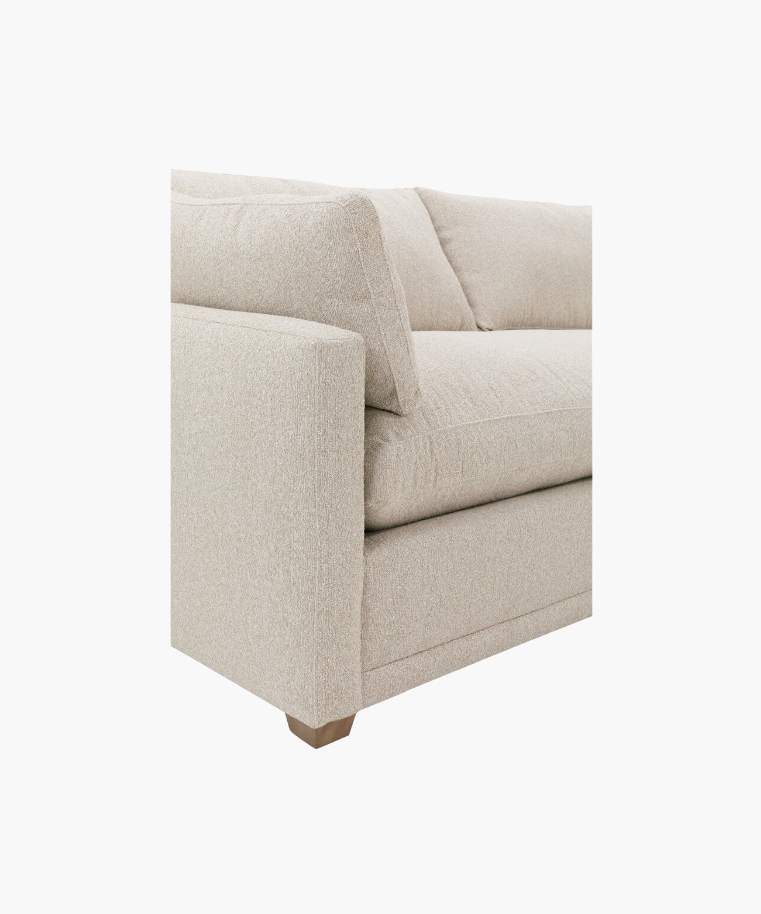 Close up of a beige sectional sofa on a white background.