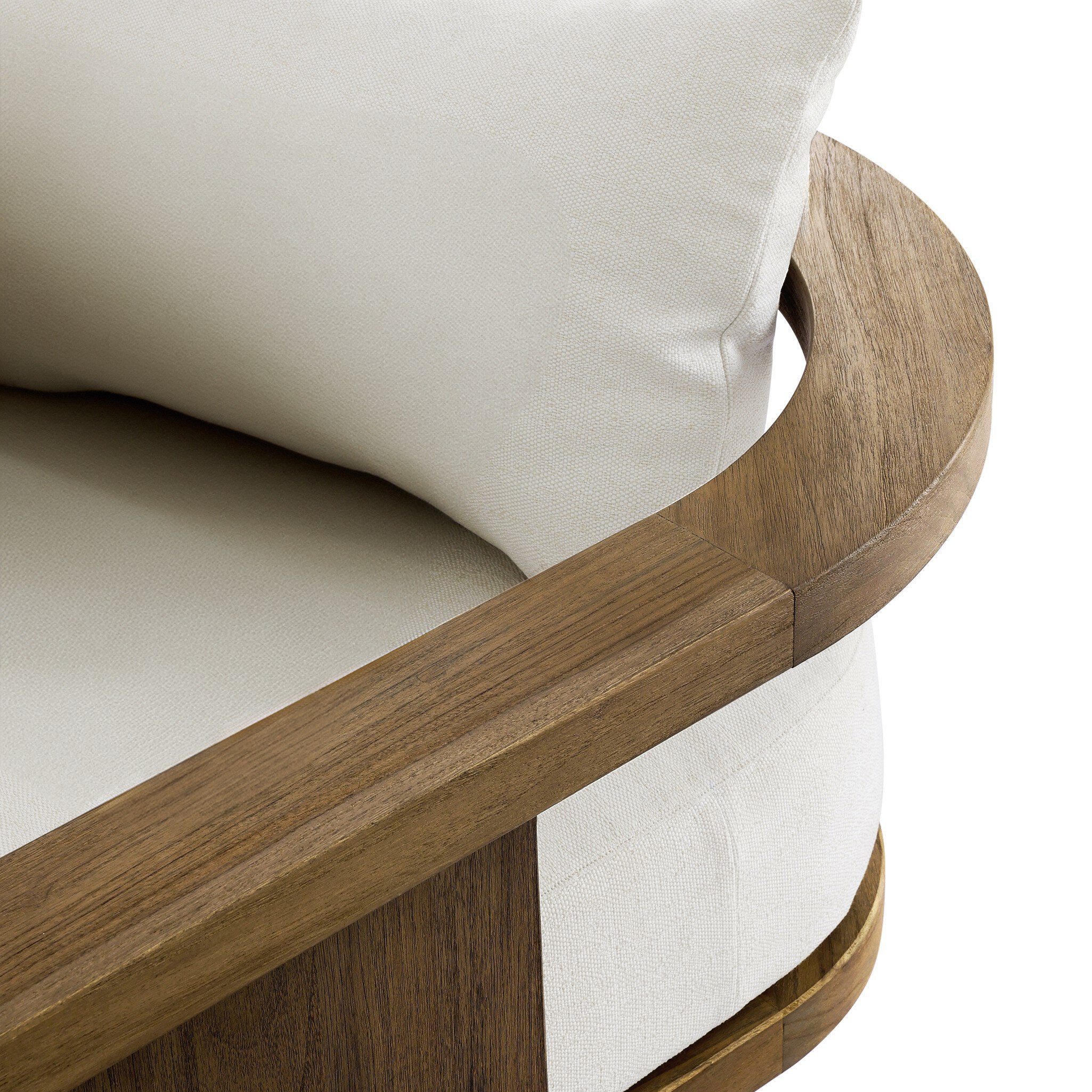 Close up of a outdoor sofa highlighting the white cushions and curved wooden frame. 