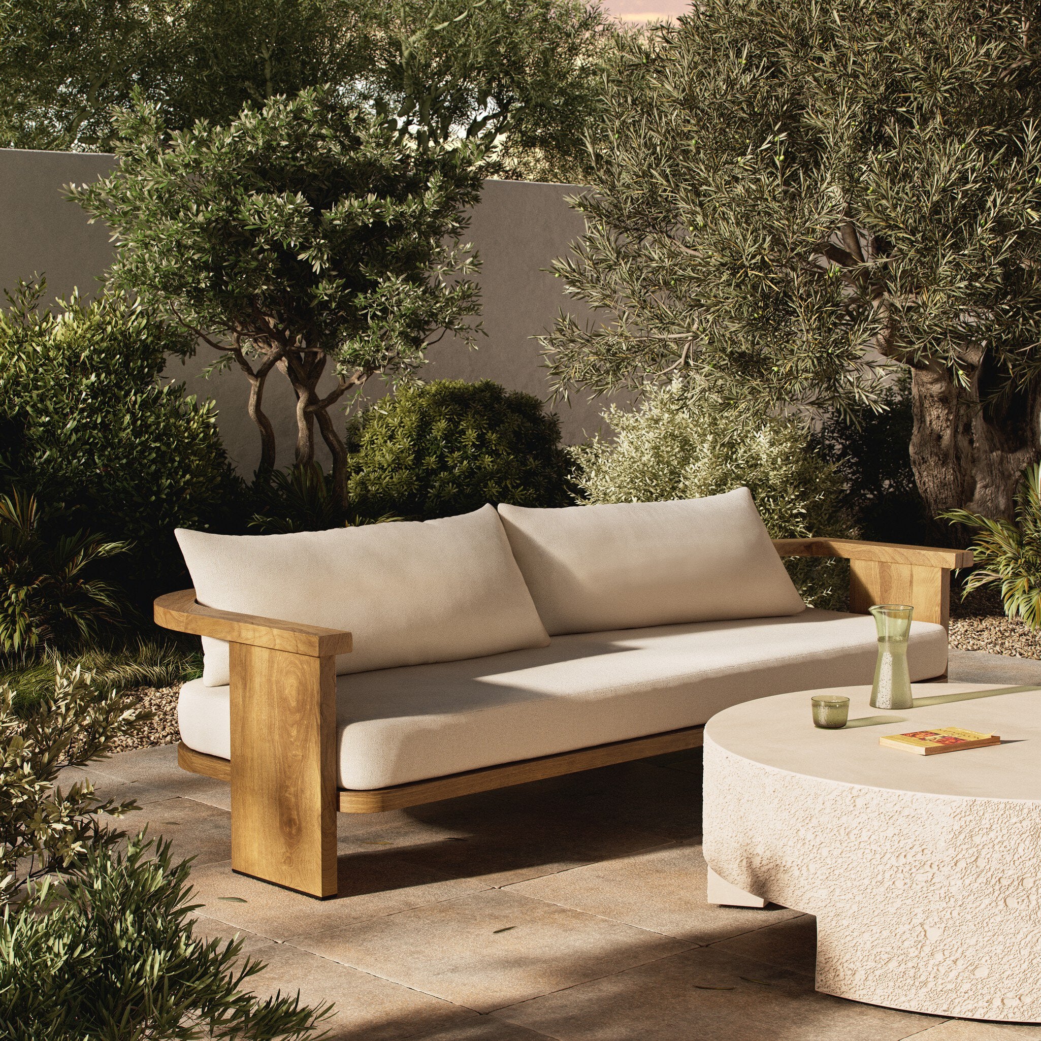 Outdoor patio set with wooden frame and beige cushions in a garden setting.