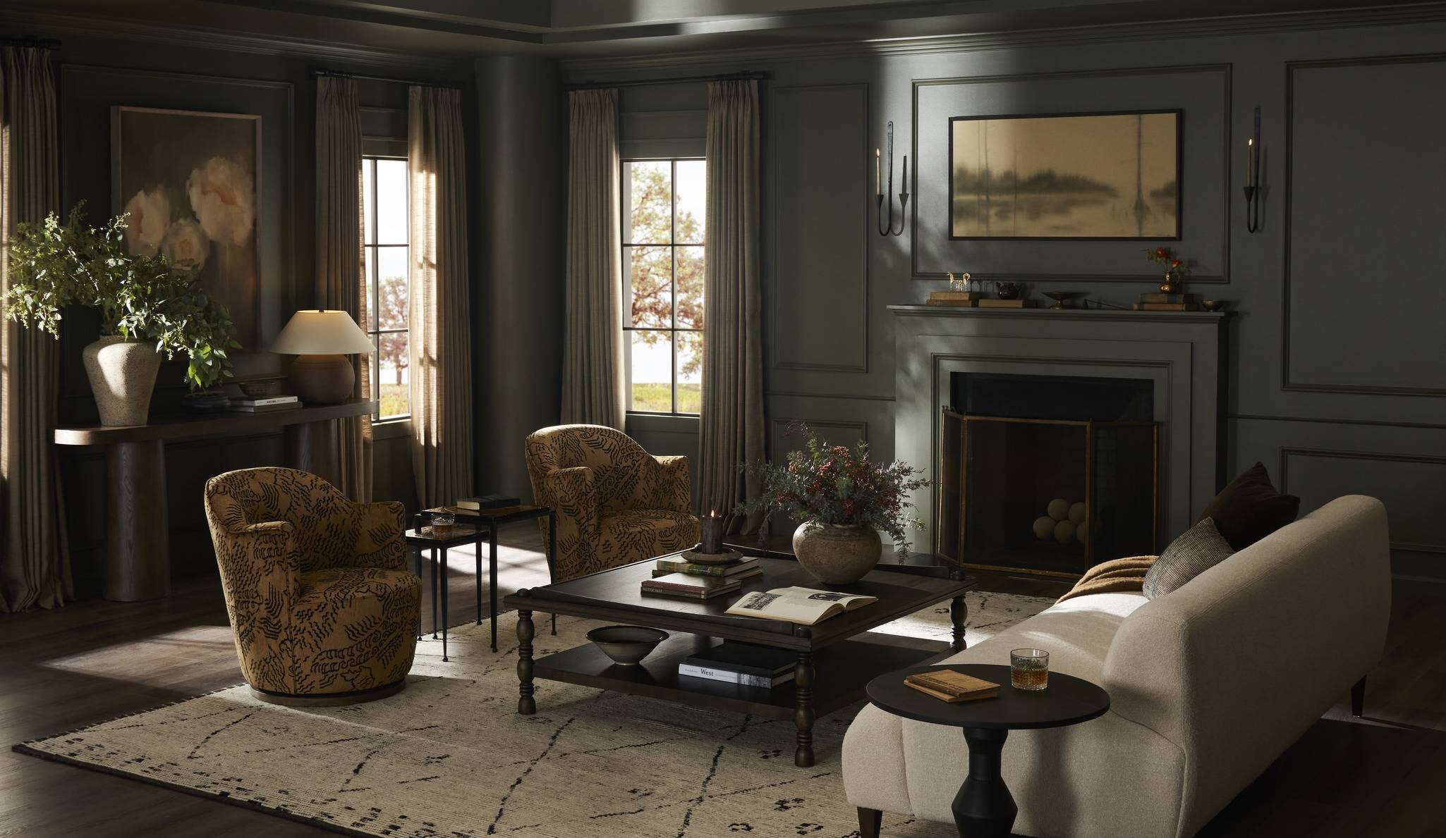 Cozy living room with a fireplace, chairs, and a coffee table.