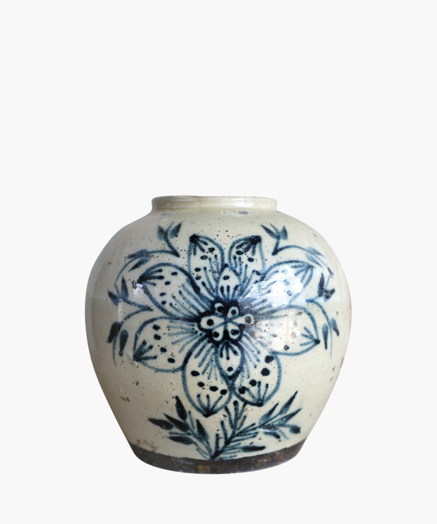 A cream toned vintage vase features a large, intricate blue floral design with leaves. The style is traditional, conveying a rustic and artistic feel.